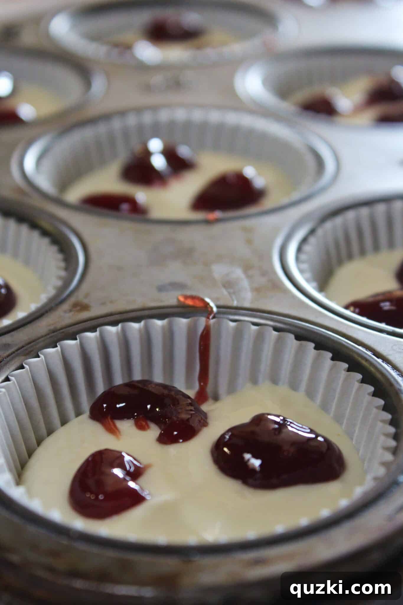 Decadent Mini Raspberry Cheesecake Cups 10 Small dots of raspberry jam on top of each mini cheesecake filling.