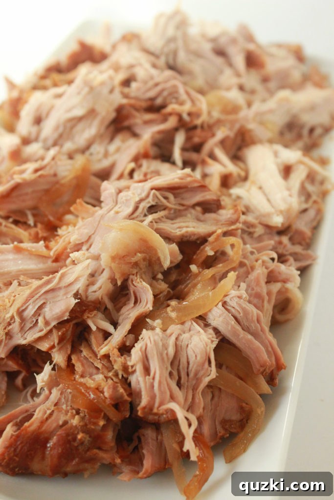 Shredded Korean pork roast with cooked onions mixed in, creating a flavorful taco filling.