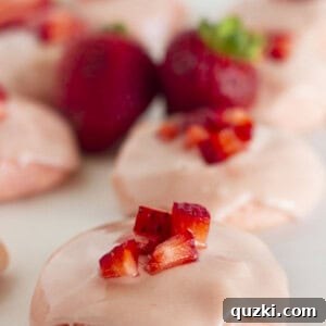 Strawberry cake mix cookies on a white tray with fresh strawberries.