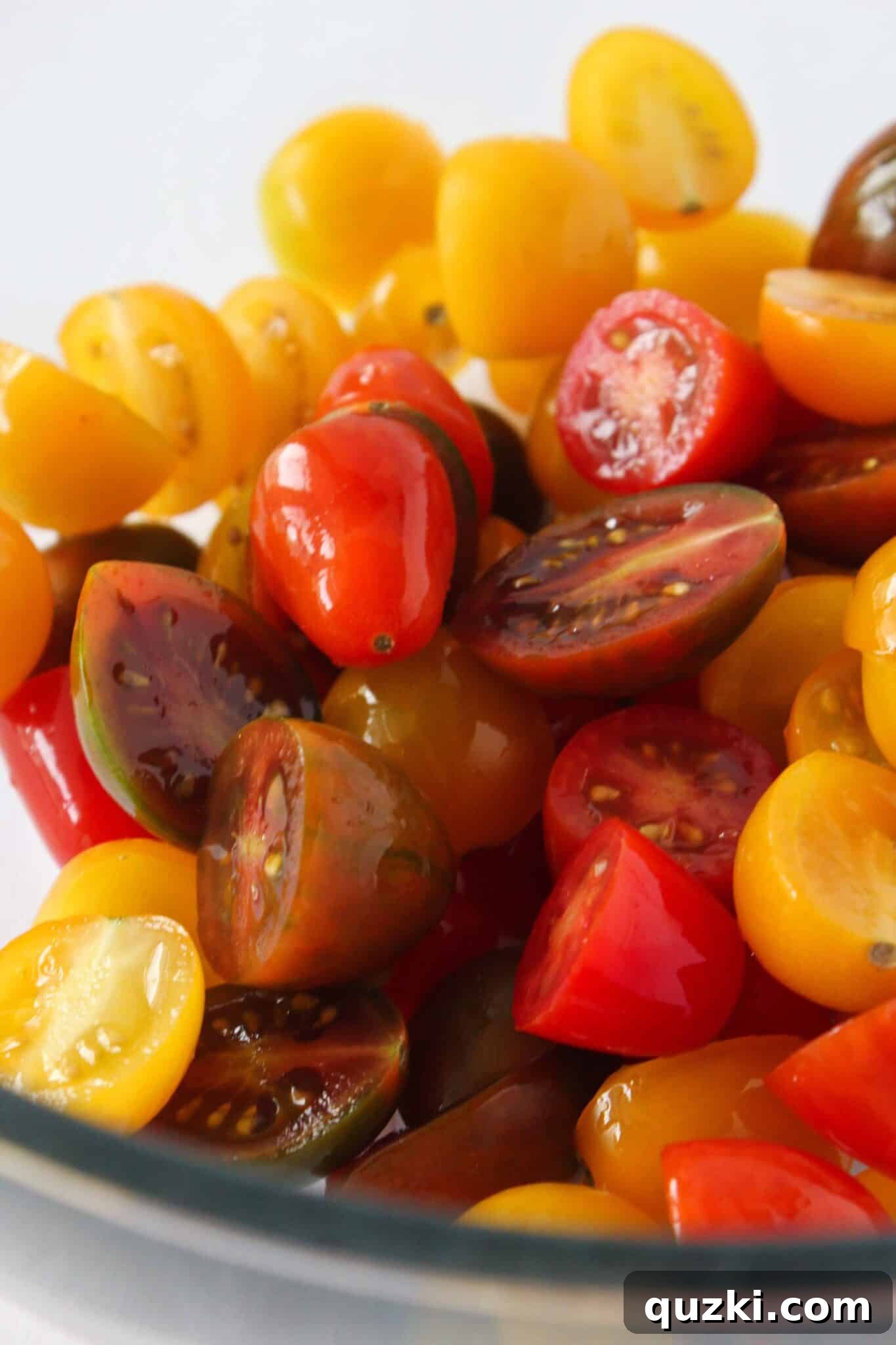 Quick Bruschetta Salad 4 Fresh, vibrant cherry tomatoes being halved on a cutting board, preparing them for the bruschetta mixture.
