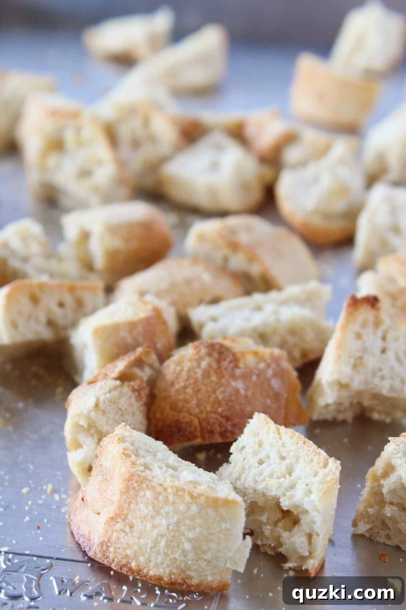 Quick Bruschetta Salad 10 A chef cutting the garlic-rubbed toasted bread into small, uniform bite-sized pieces to create homemade croutons for the salad.