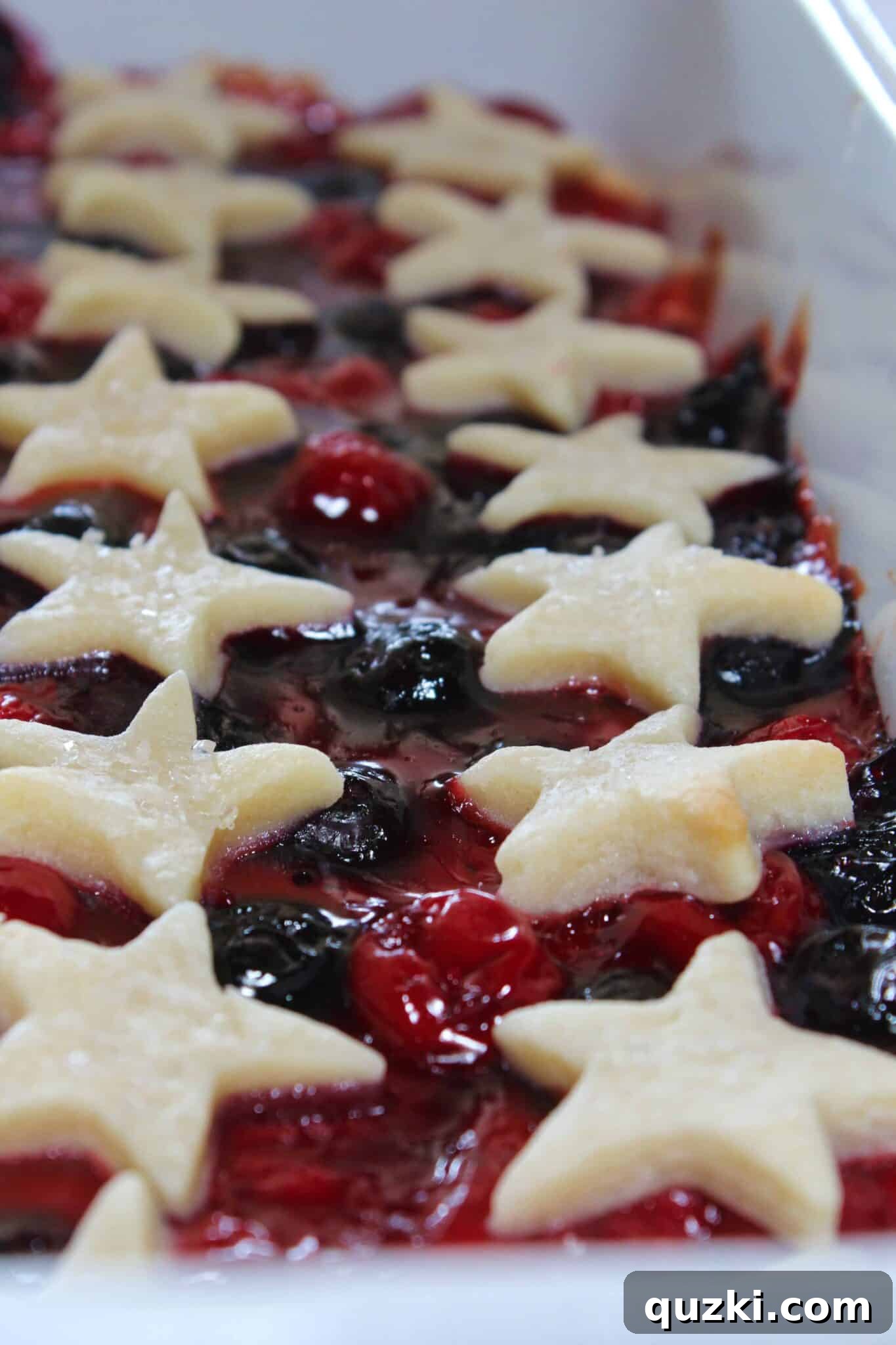 Festive Fourth of July Cookie Bars 11 The fully baked 4th of July Cookie Bars, with bubbly fruit filling and golden-brown cookie stars, cooling on a rack.