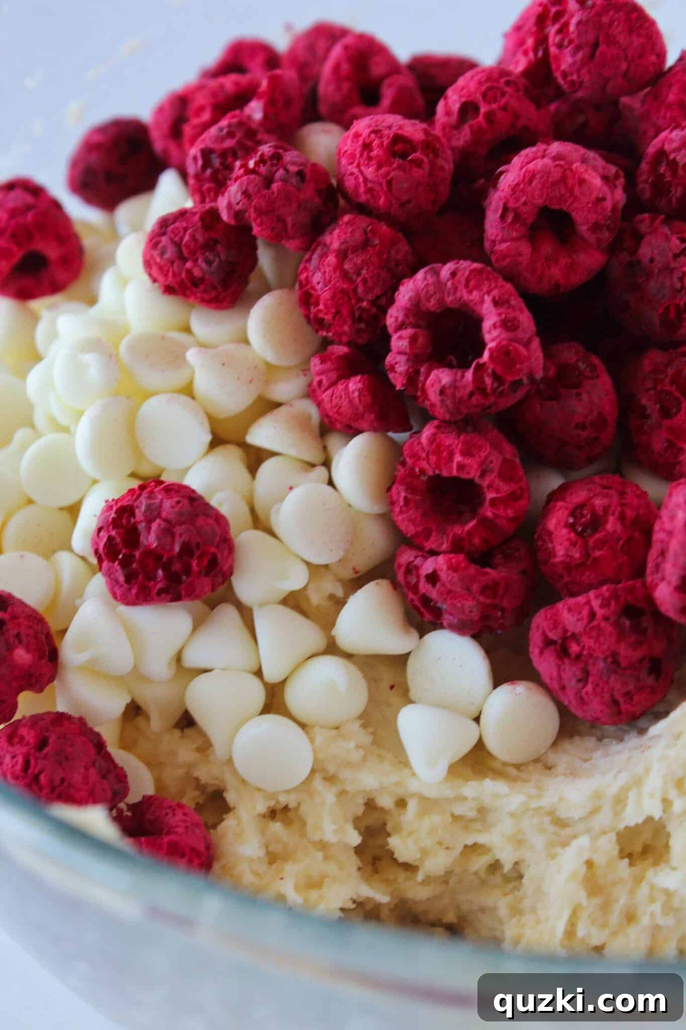Subway's Iconic Raspberry Cheesecake Cookies Make Them At Home 6 White chocolate chips and freeze-dried raspberries being gently folded into the cookie dough for Copycat Subway Raspberry Cheesecake Cookies.