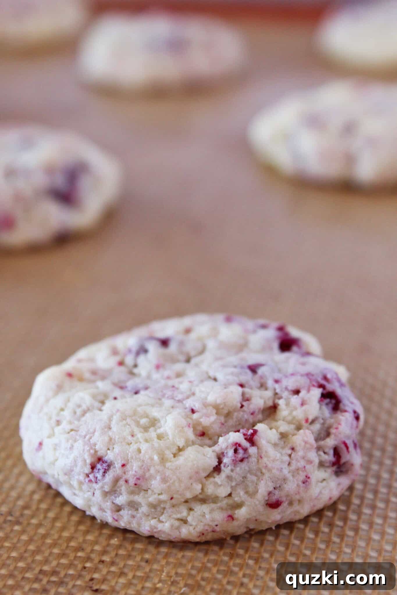 Subway's Iconic Raspberry Cheesecake Cookies Make Them At Home 10 Freshly baked Copycat Subway Raspberry Cheesecake Cookies cooling on a wire rack, showing their golden edges and soft centers.