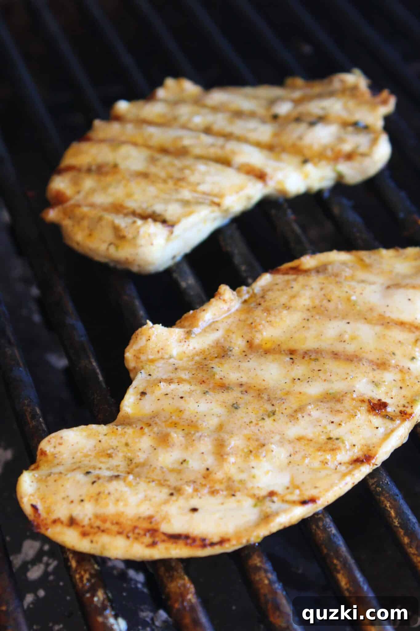 Simple Marinade for Succulent Chicken 8 Juicy marinated chicken breasts searing on a hot grill, creating perfect char marks.