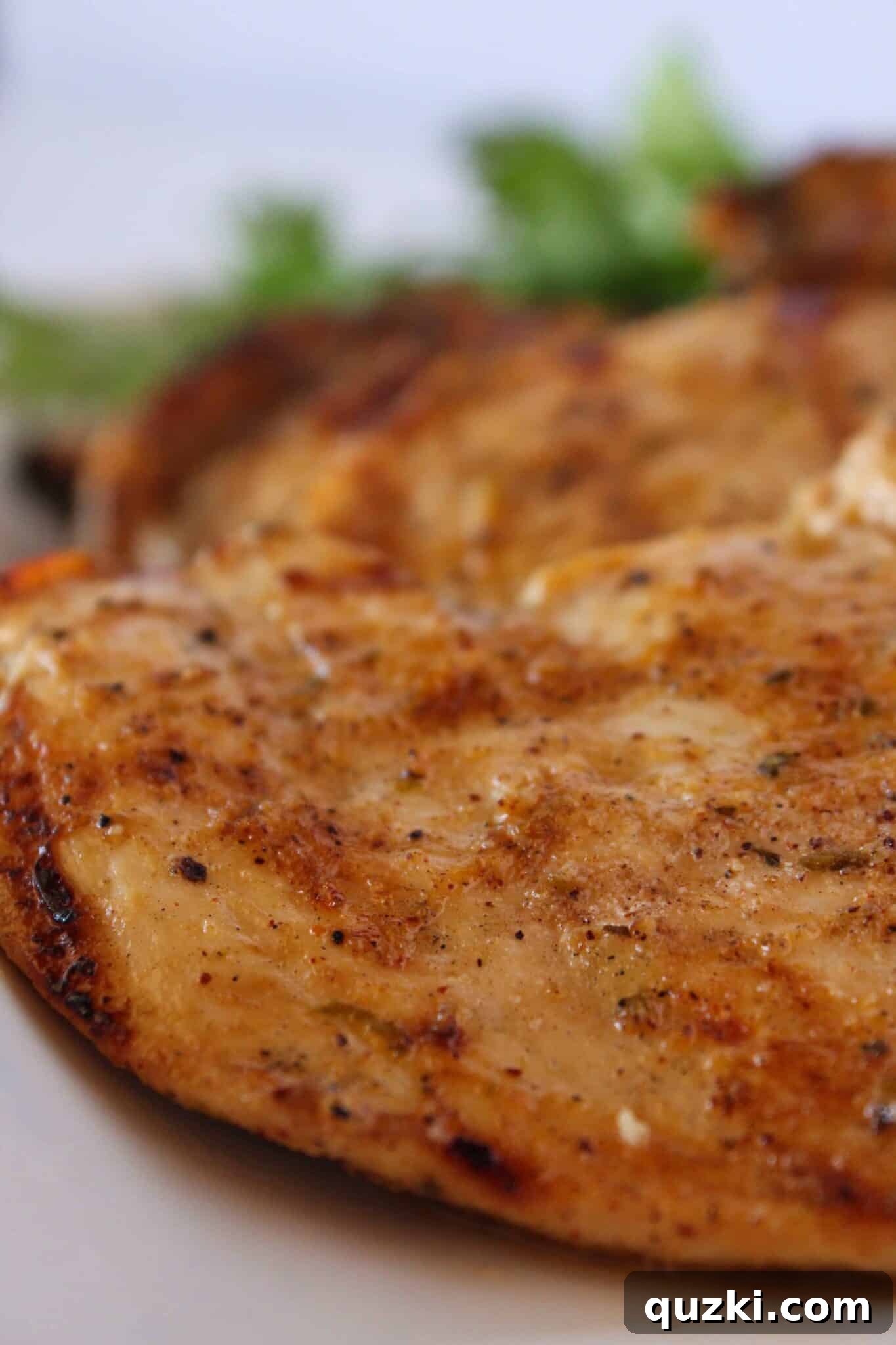 Simple Marinade for Succulent Chicken 9 Beautifully grilled marinated chicken breasts served on a tray, garnished with fresh herbs.