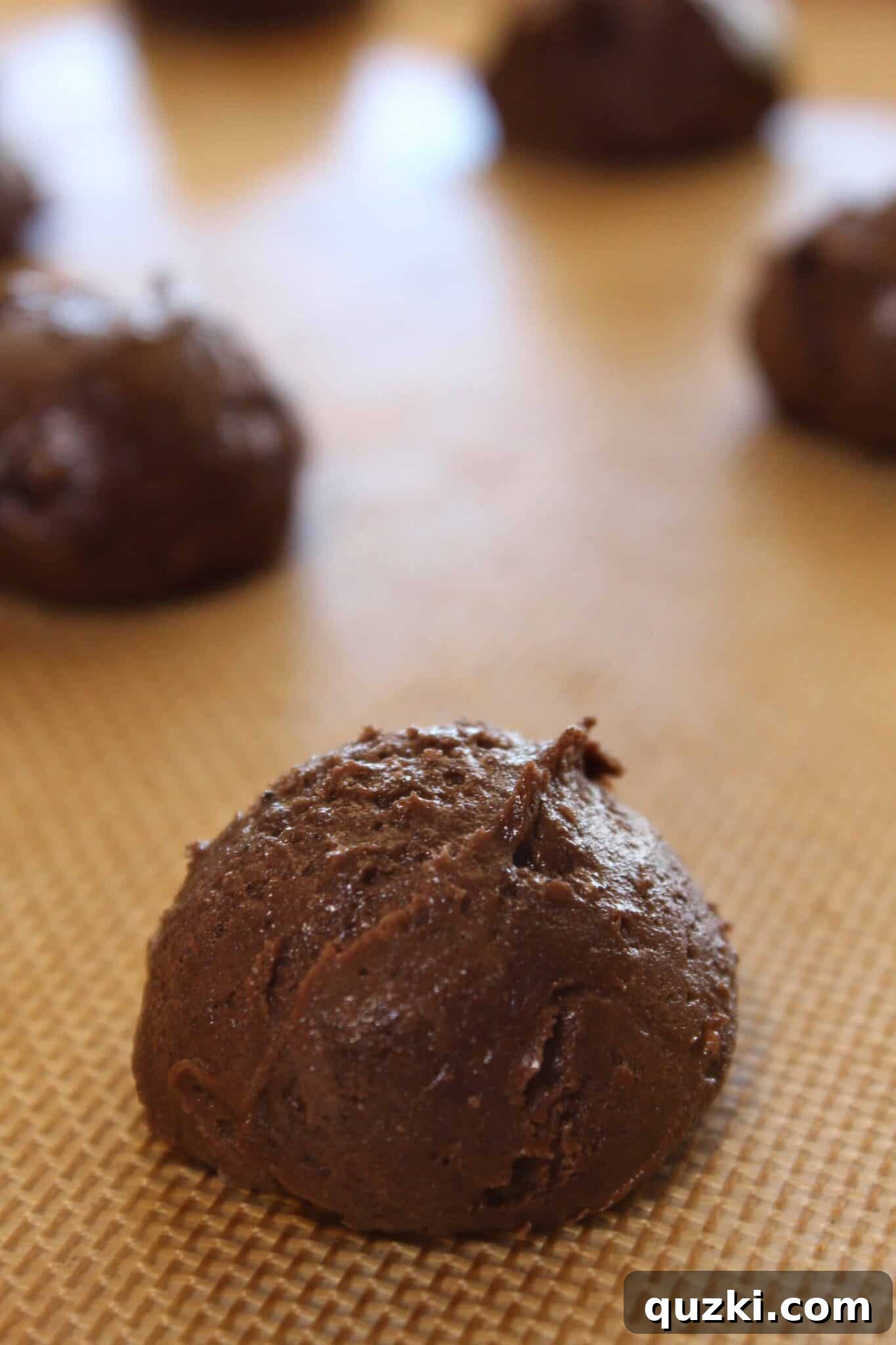 Scooping cookie dough onto a baking sheet for Mississippi Mud Cookies
