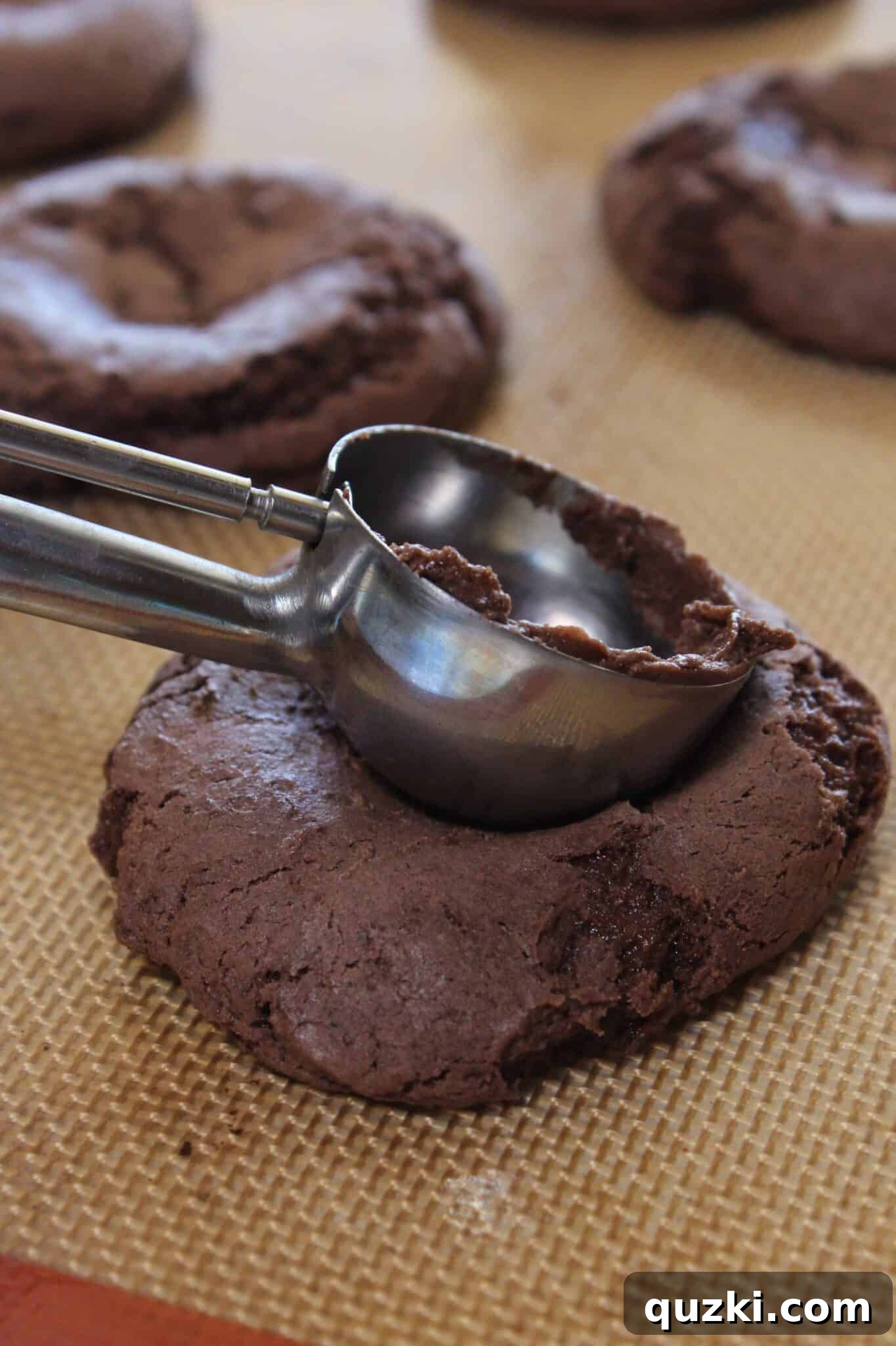 Creating an indentation in partially baked Mississippi Mud Cookies for marshmallows
