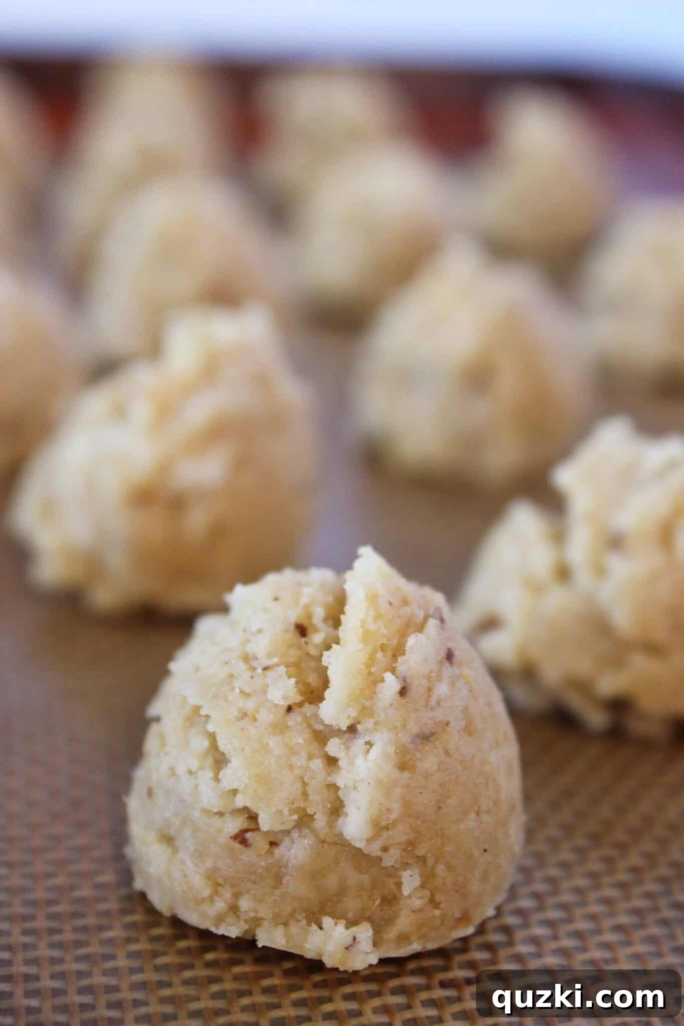 No-Bake Pecan Sandies Truffles 8 Pecan Sandies truffle mixture scooped onto a baking sheet, ready to be rolled