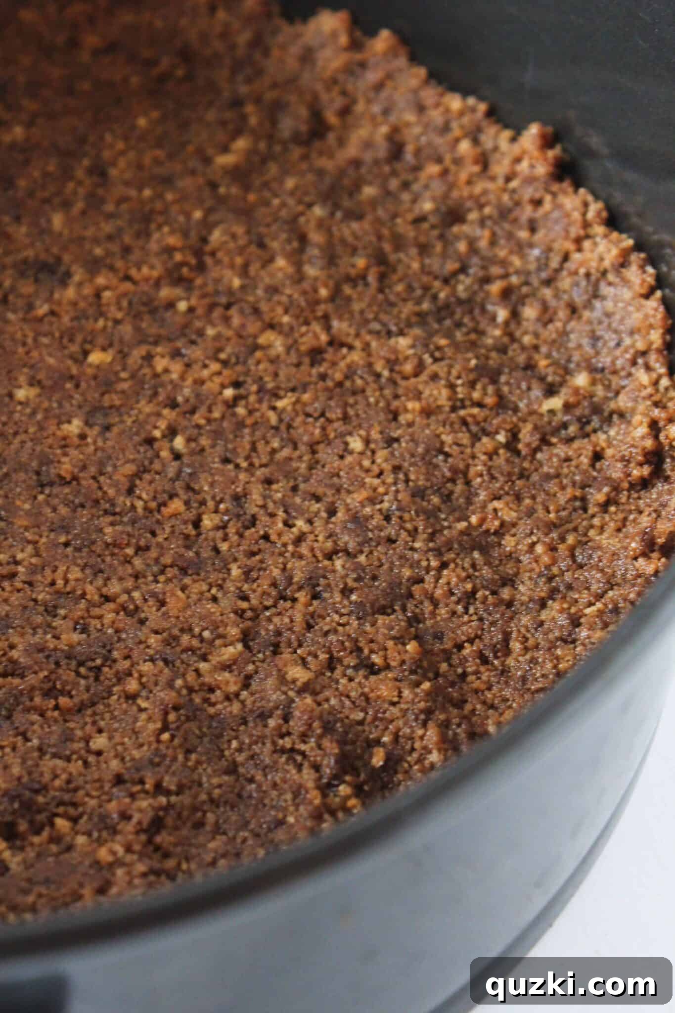 Ultimate Chocolate Chip Cookie Cheesecake Crust 7 A finished Chocolate Chip Cookie Cheesecake Crust in a springform pan, perfectly formed.