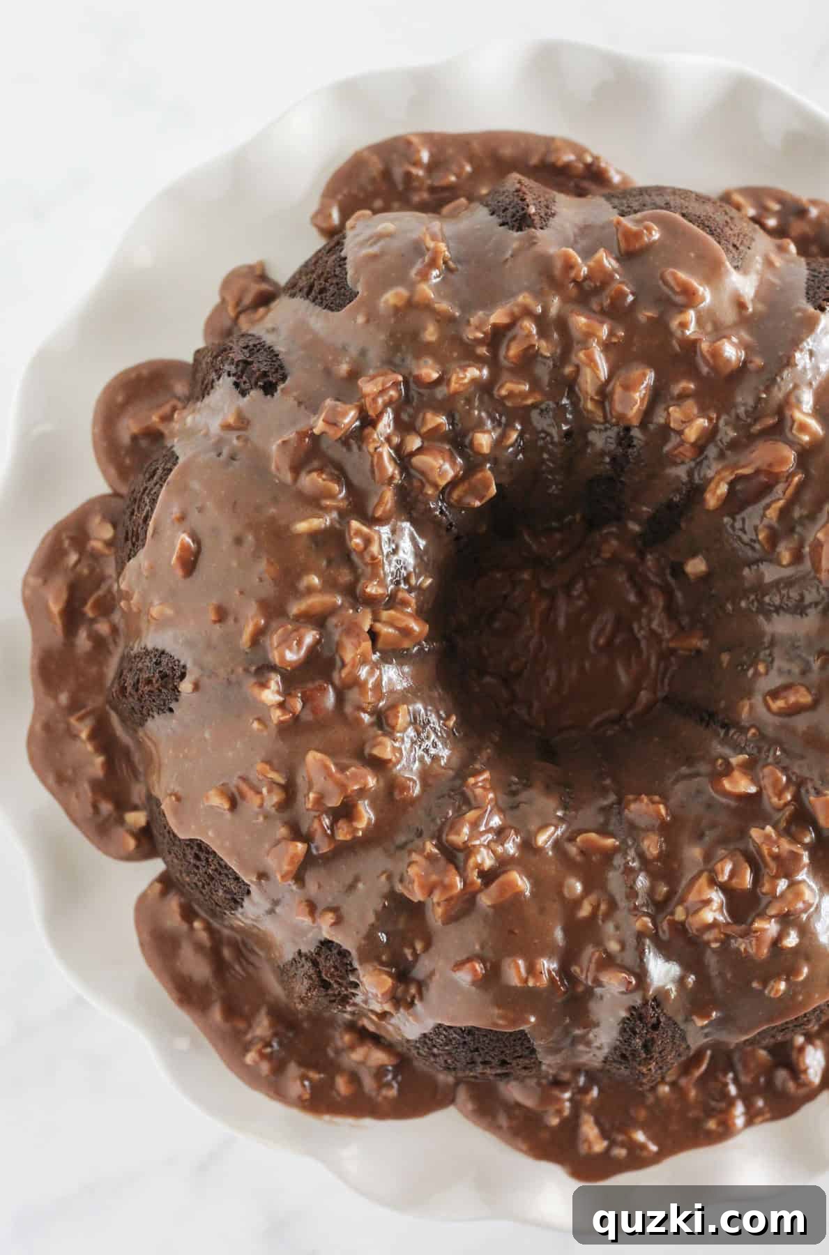 Decadent Texas Sheet Cake Bundt 2 A beautifully frosted Texas Sheet Cake Bundt Cake with a rich chocolate pecan glaze and chopped pecans.