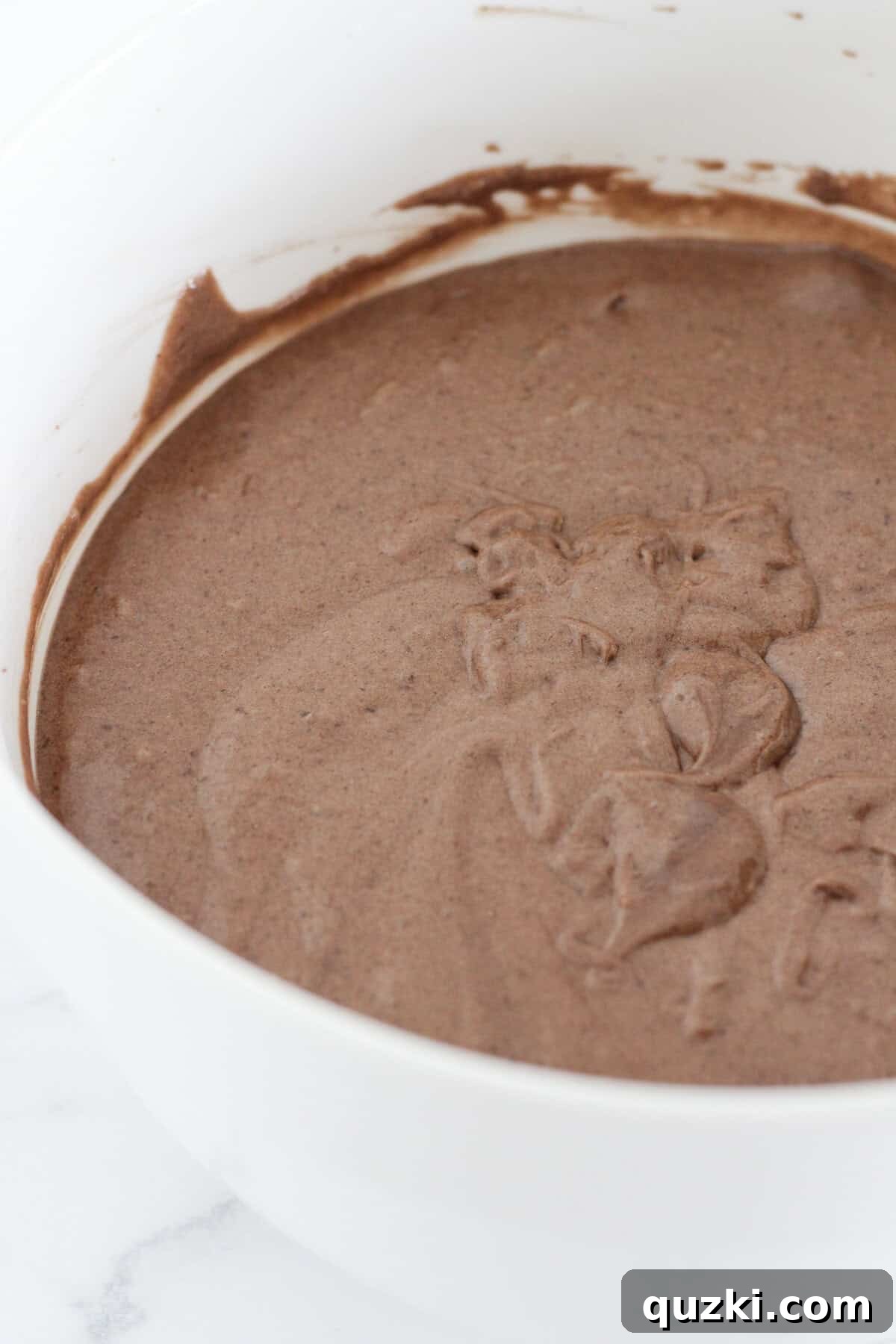 Decadent Texas Sheet Cake Bundt 4 Mixing the chocolate cake batter in a bowl, showing the smooth, rich consistency before it's poured into the bundt pan.