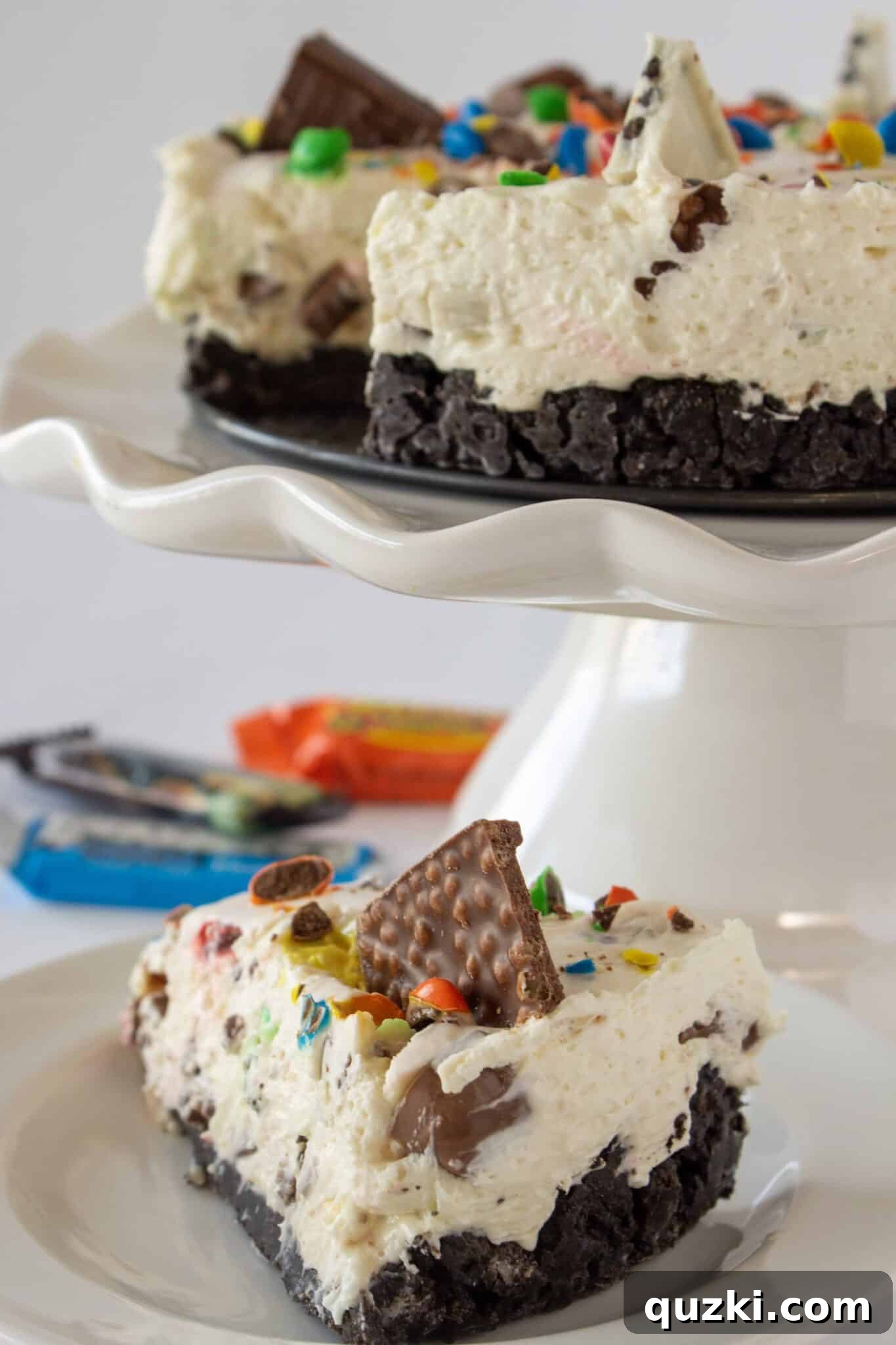 Frightfully Delicious No-Bake Candy Cheesecake 3 A delectable slice of No Bake Halloween Candy Cheesecake served on a festive plate, showcasing its rich texture and colorful candy pieces.