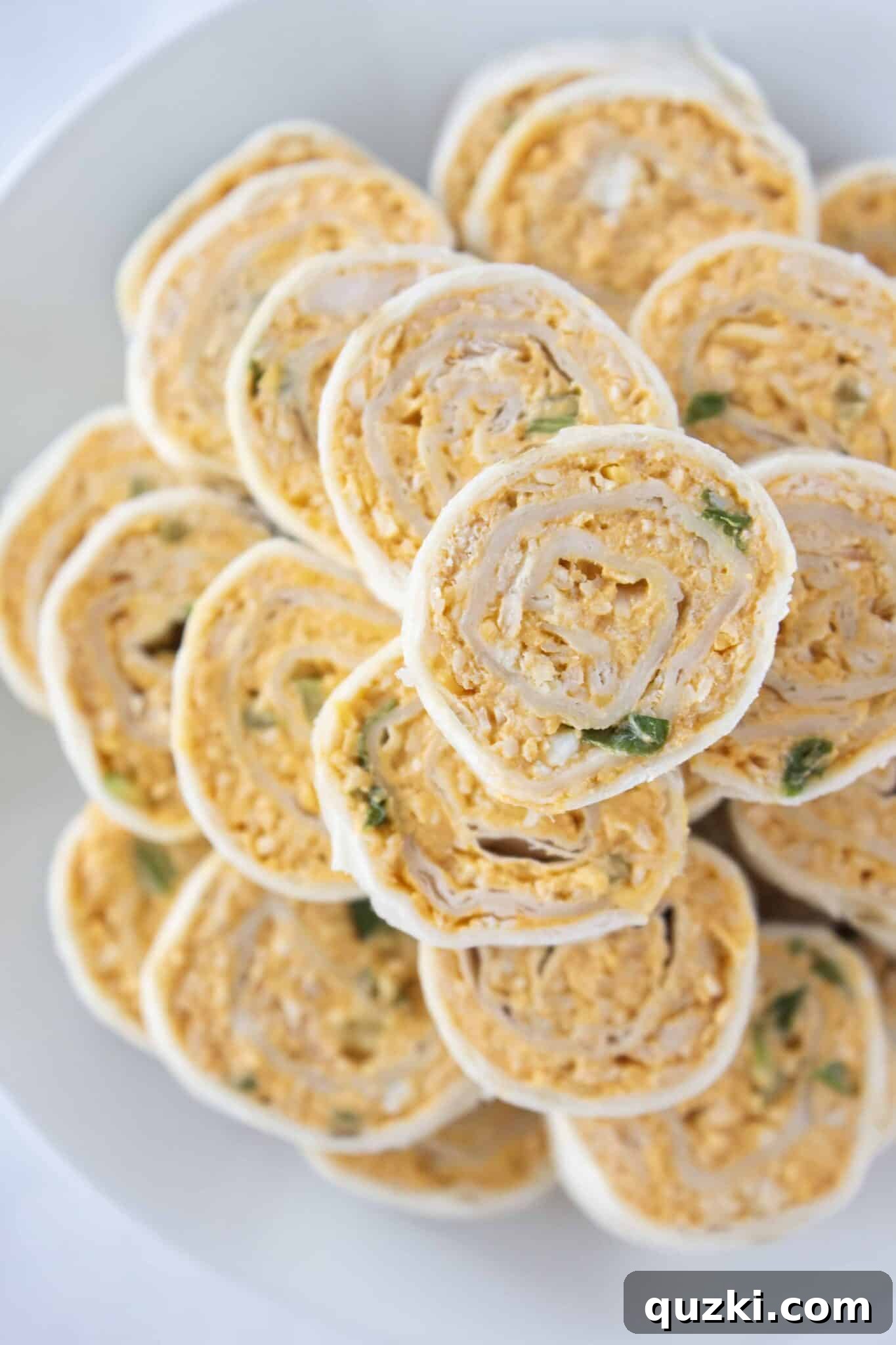 The Ultimate Buffalo Chicken Wrap Recipe 2 Finished buffalo chicken tortillas on a tray and ready to serve, showcasing vibrant colors and perfect slices.
