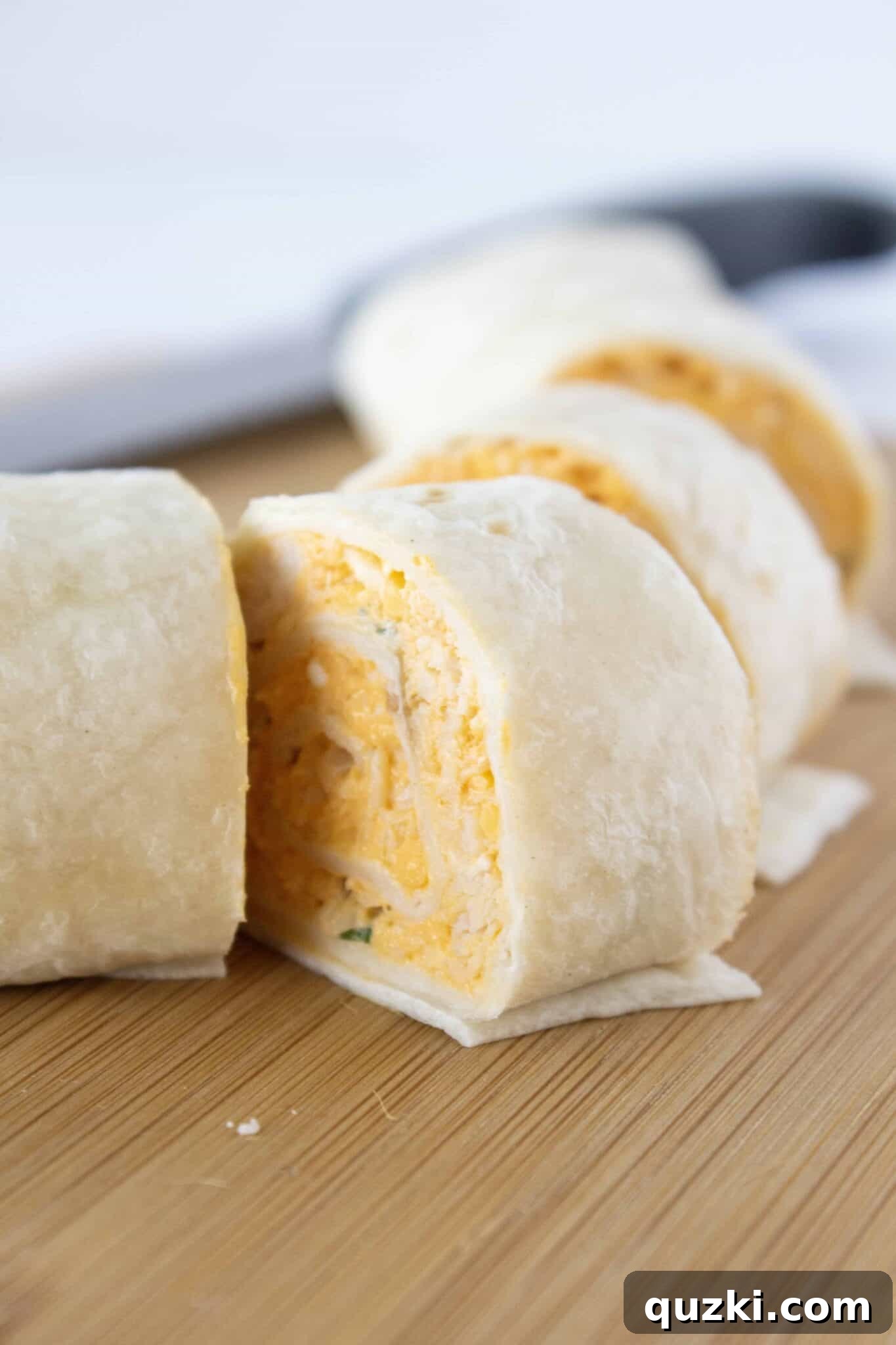 The Ultimate Buffalo Chicken Wrap Recipe 7 Cutting the chilled Buffalo Chicken Tortilla Wraps into perfect 1/2-inch slices using a serrated knife.