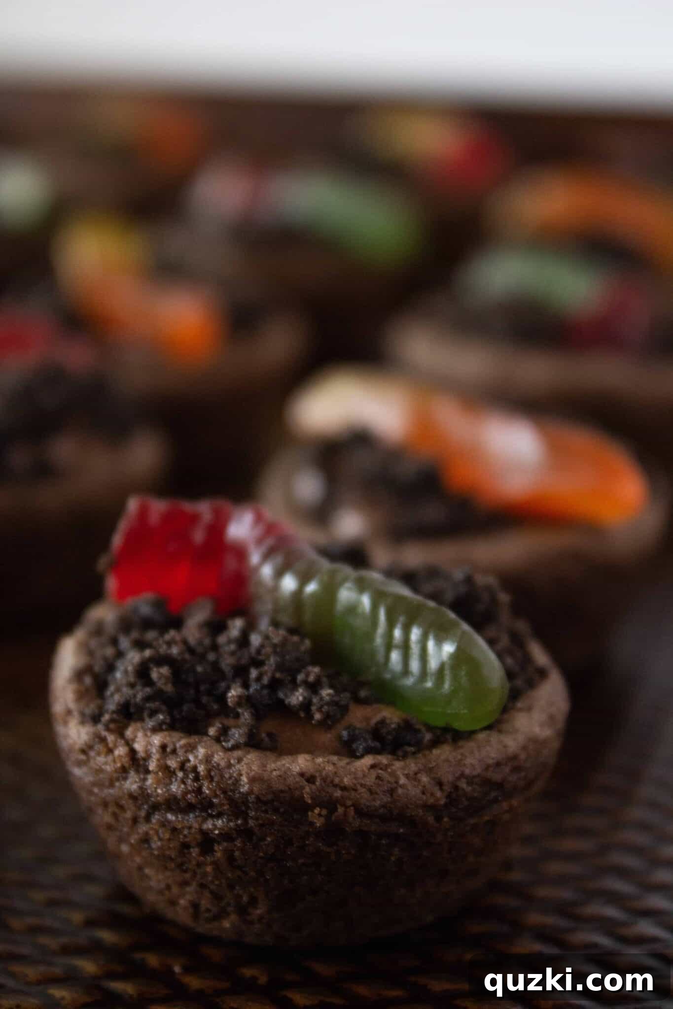 Garden Dirt Cookie Bites 12 The final touch: adorning the Dirt Cup Cookie Bites with adorable gummy worms, bringing the playful 'dirt cup' theme to life.