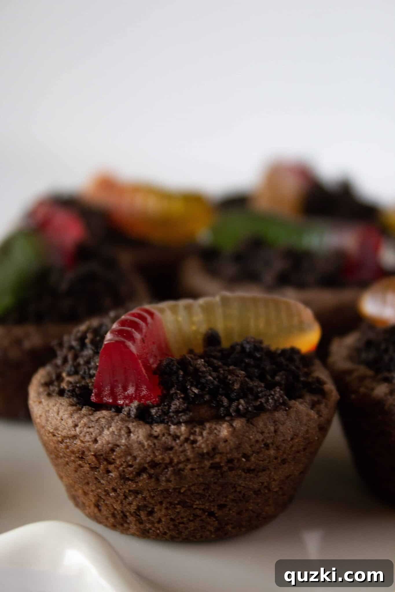 Garden Dirt Cookie Bites 13 A stunning display of finished Dirt Cup Cookie Bites presented on a elegant cake plate, ready to be served at any gathering.