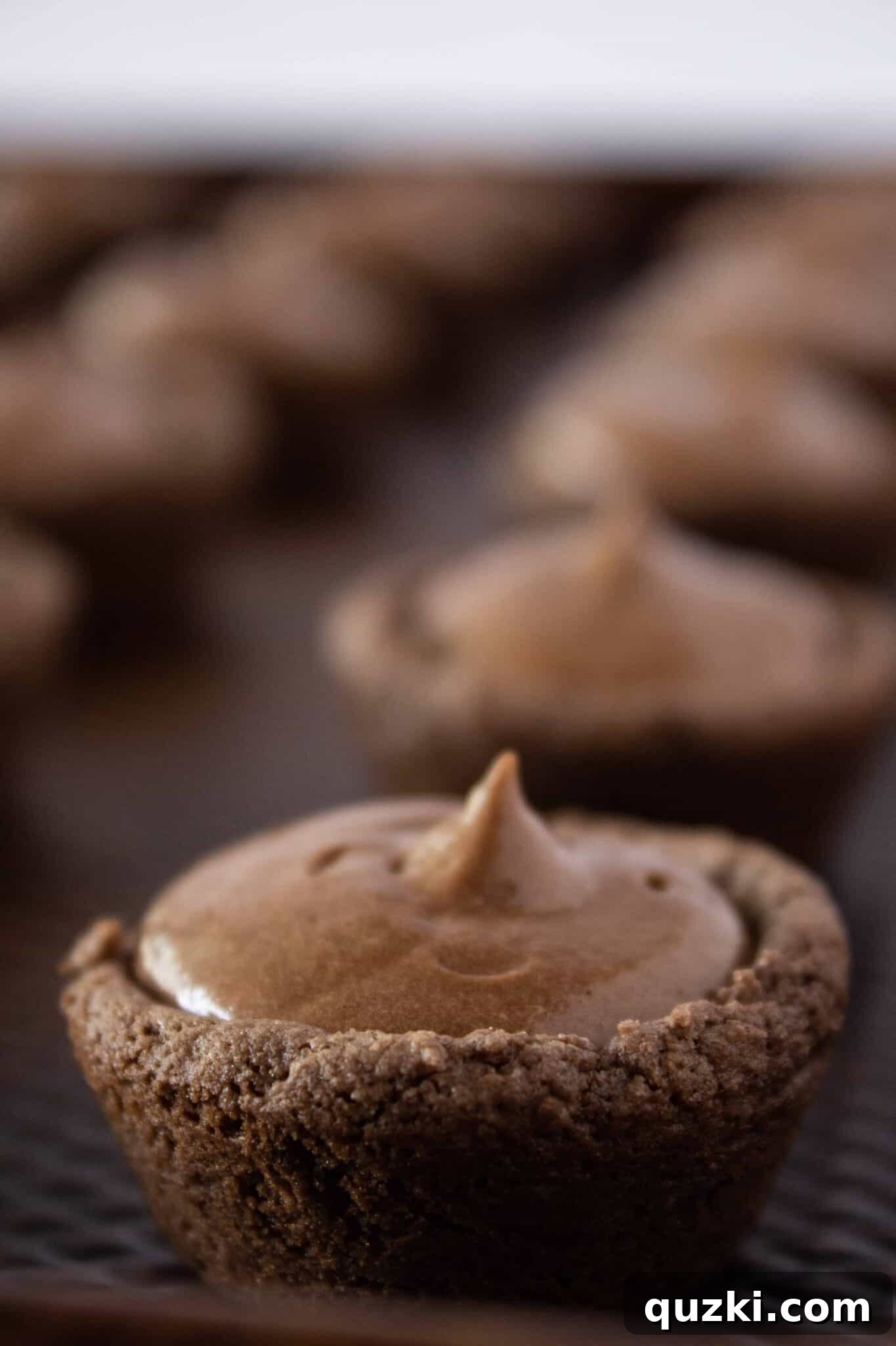 Garden Dirt Cookie Bites 10 Detailed image showing the preparation of the creamy pudding filling and the elegant process of adding it into each baked cookie cup.