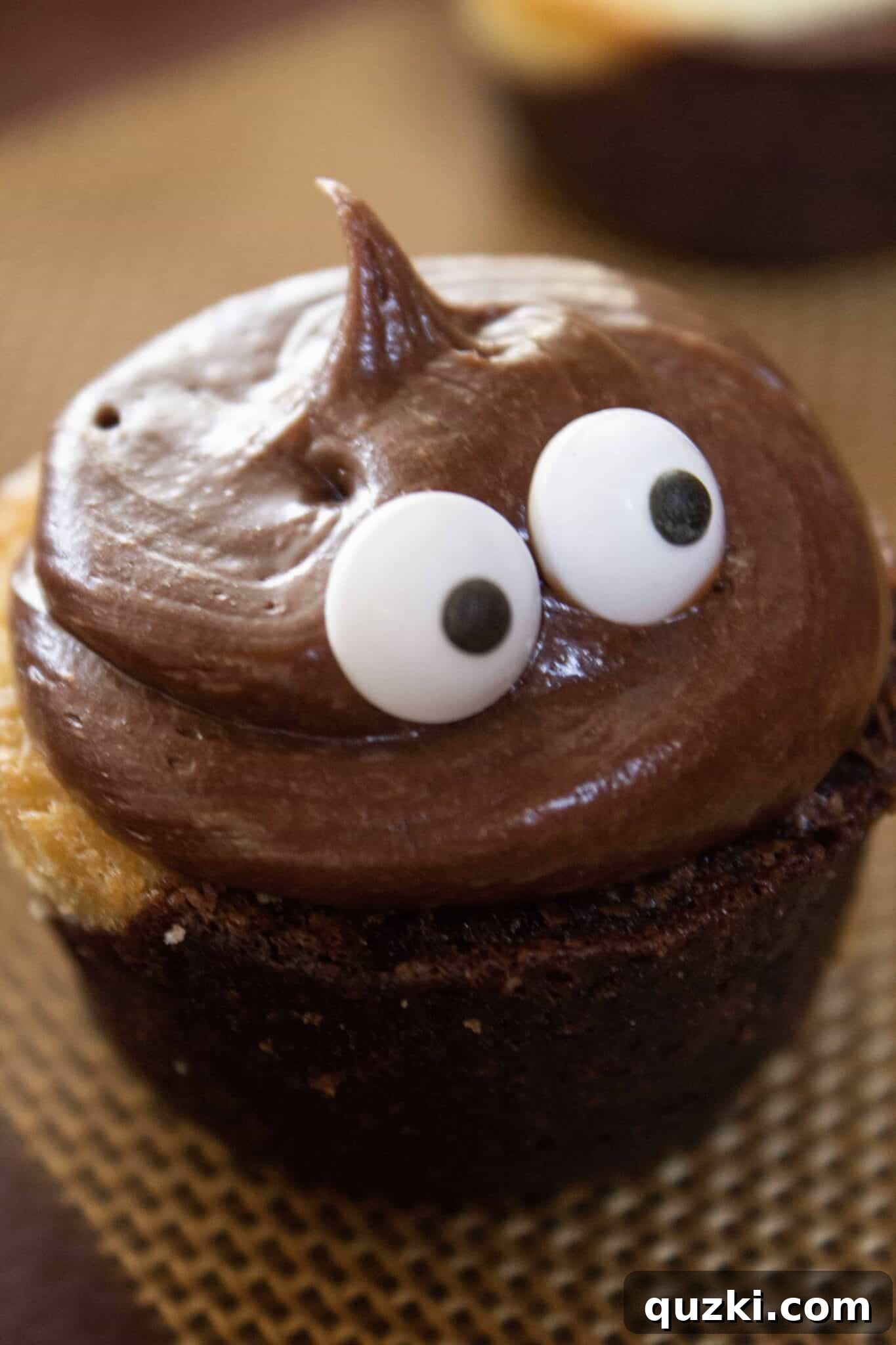 Ghoulish Goodness: Brownie Bat Bites for a Haunting Halloween 5 Attaching two edible eyeballs to the chocolate frosting on a brownie bite, bringing the Spooky Bat to life.