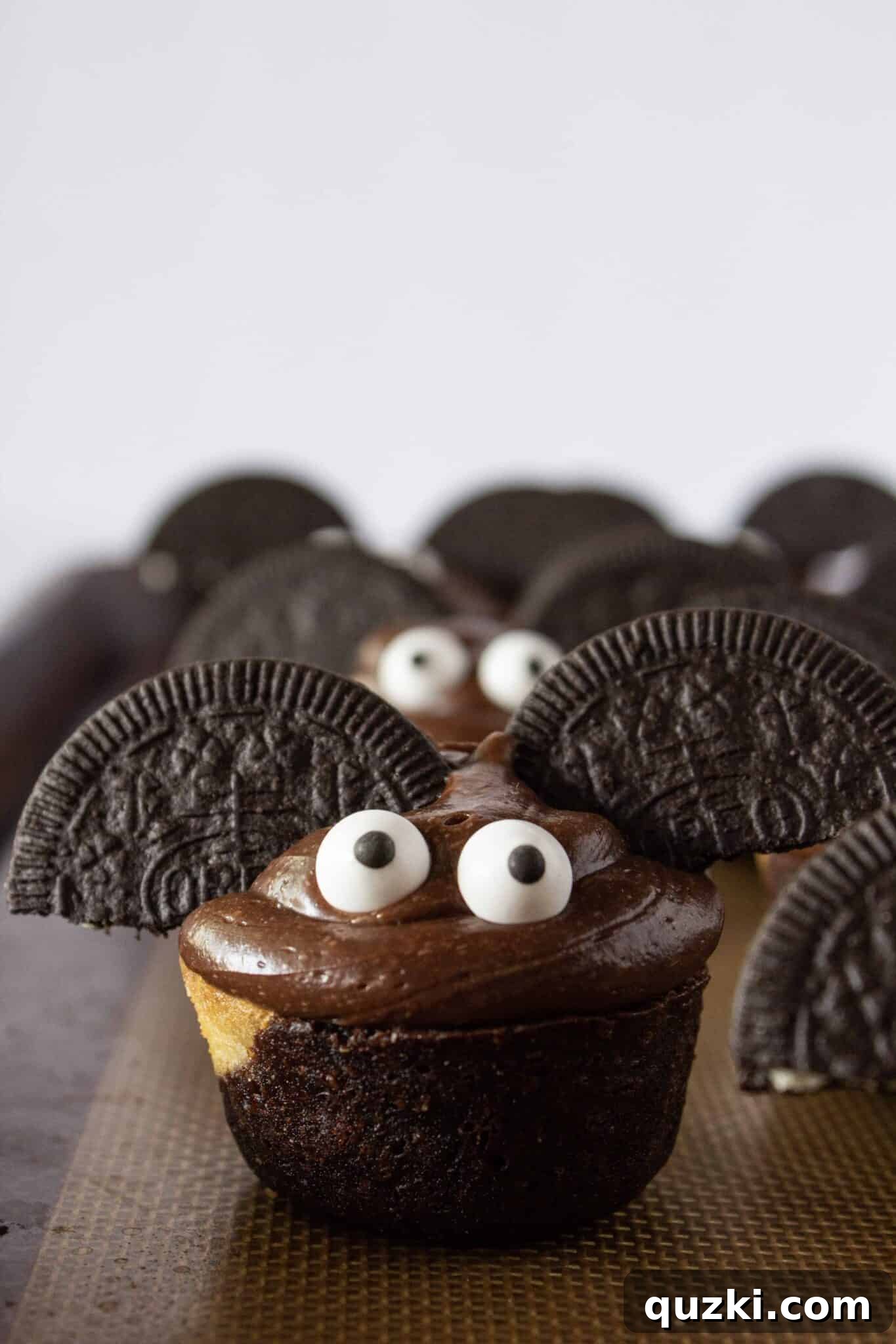Ghoulish Goodness: Brownie Bat Bites for a Haunting Halloween 7 A tray filled with many finished Spooky Brownie Bat Bites, ready to be served and enjoyed at a Halloween gathering.