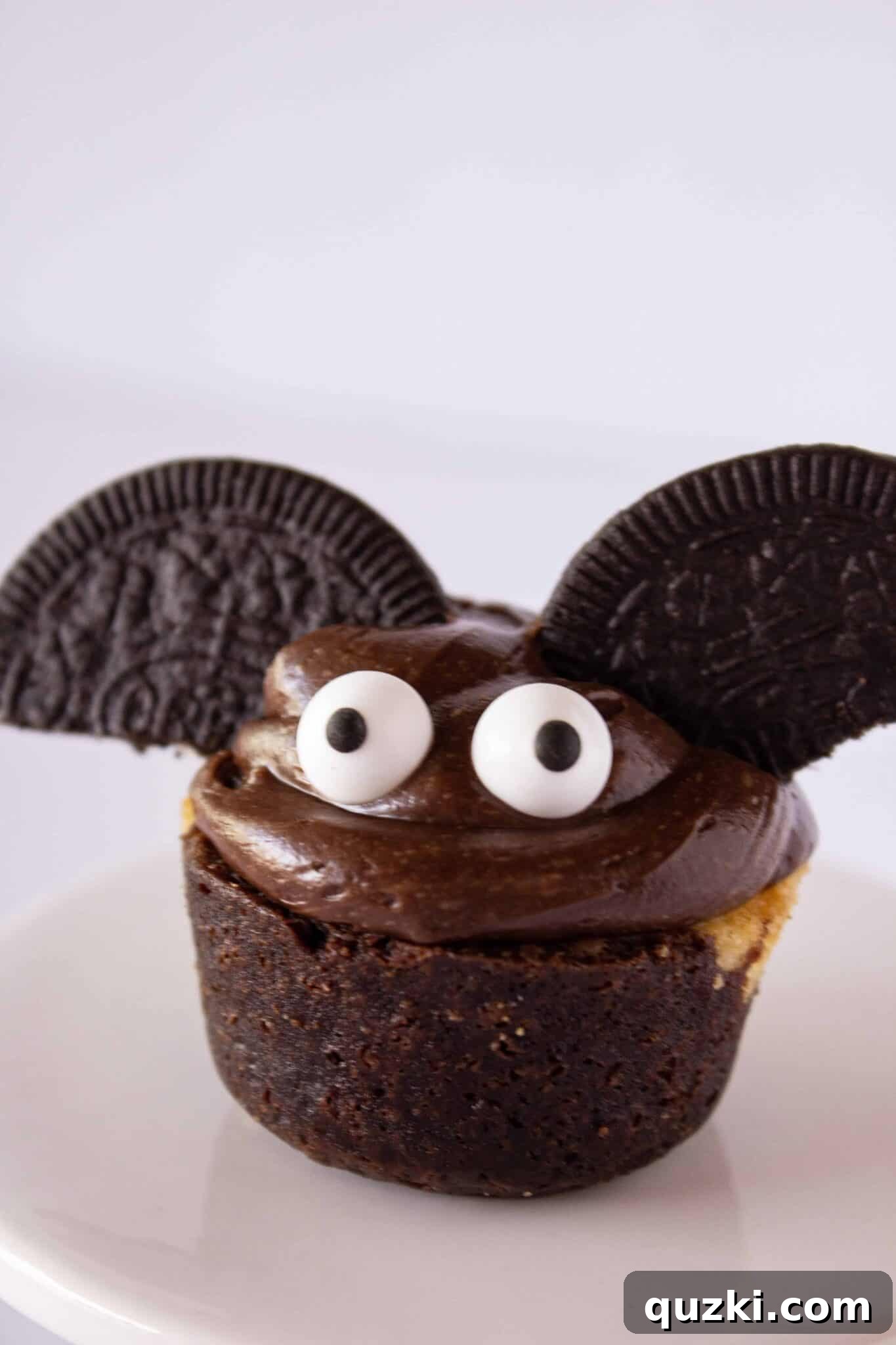 Ghoulish Goodness: Brownie Bat Bites for a Haunting Halloween 8 A festive display of Spooky Brownie Bat Bites and other Halloween treats on a serving platter, ready for a party.