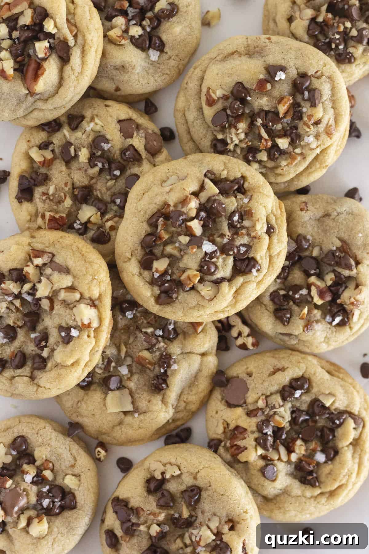 Artisan Chocolate Chip and Pecan Cookies 6 A beautiful dozen of golden-brown chocolate chip and pecan cookies arranged on a pristine white tray.