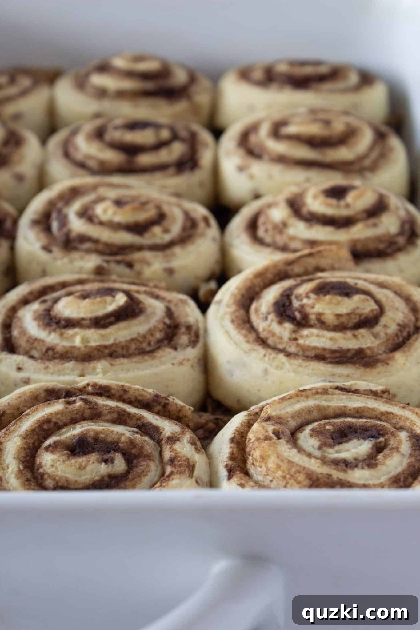 Baked caramel pecan sticky buns bubbling in the oven, showing golden brown rolls and gooey caramel