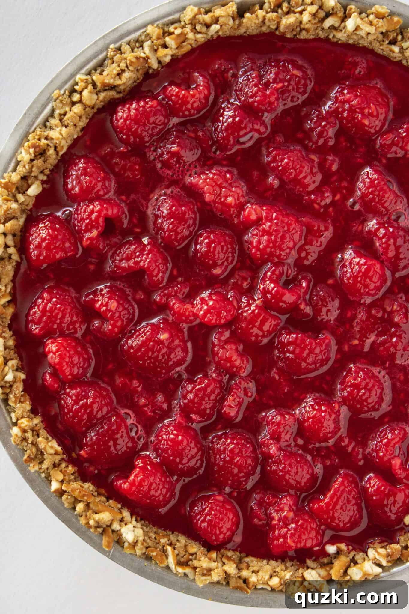 Chilled Raspberry Pretzel Crunch Pie 9 Making the raspberry jello topping and carefully adding it to the top of the cream cheese layer.