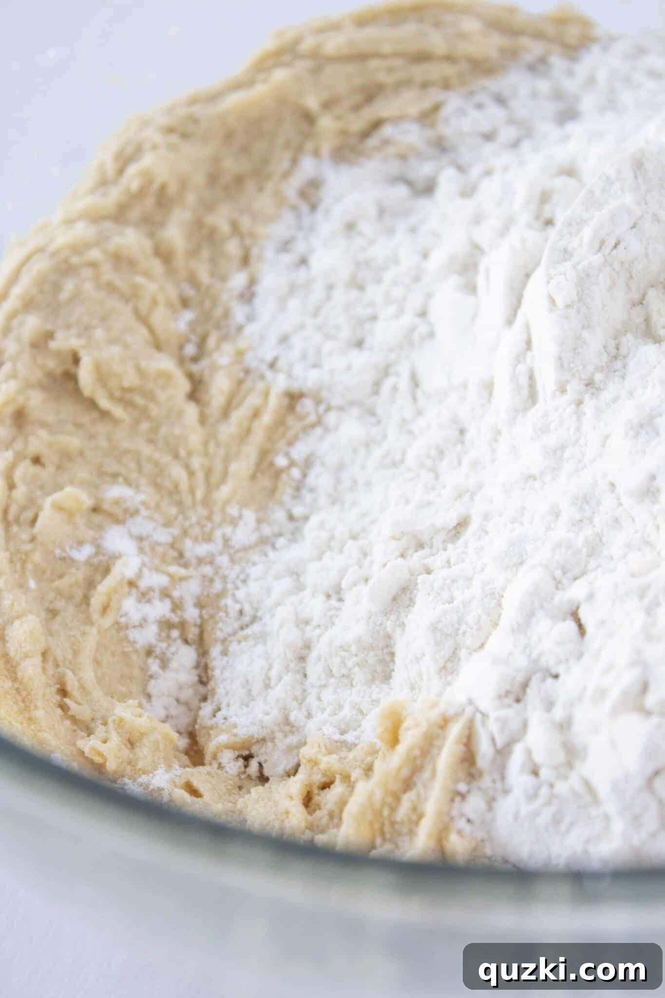 Sweeten Your Christmas Morning: Eggnog Coffee Cake 4 Mixing the cake batter for Eggnog Coffee Cake, showing butter, sugar, and egg in a bowl.