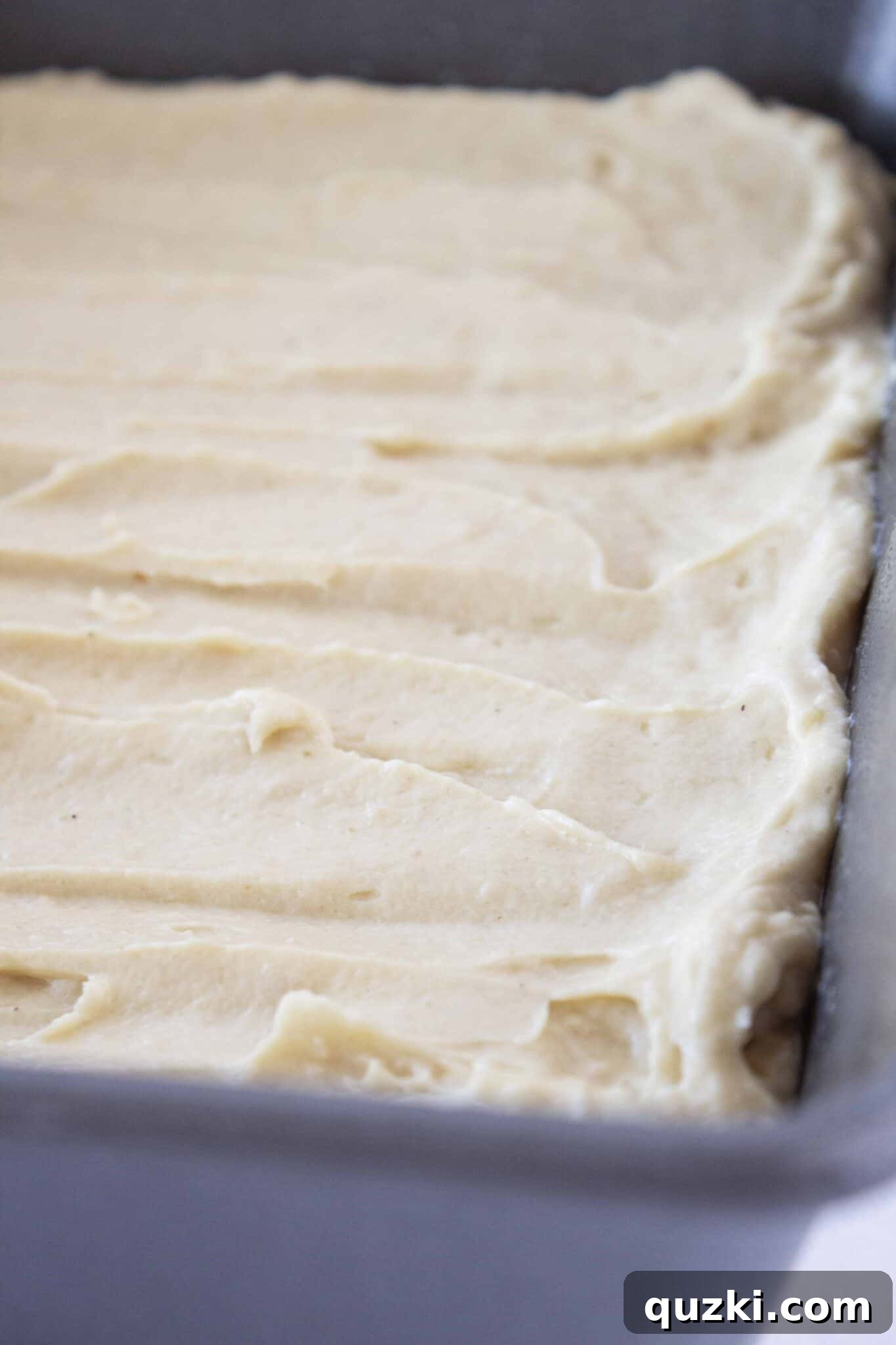 Sweeten Your Christmas Morning: Eggnog Coffee Cake 6 Eggnog Coffee Cake batter spread evenly in a 9x9 baking pan, ready for topping.