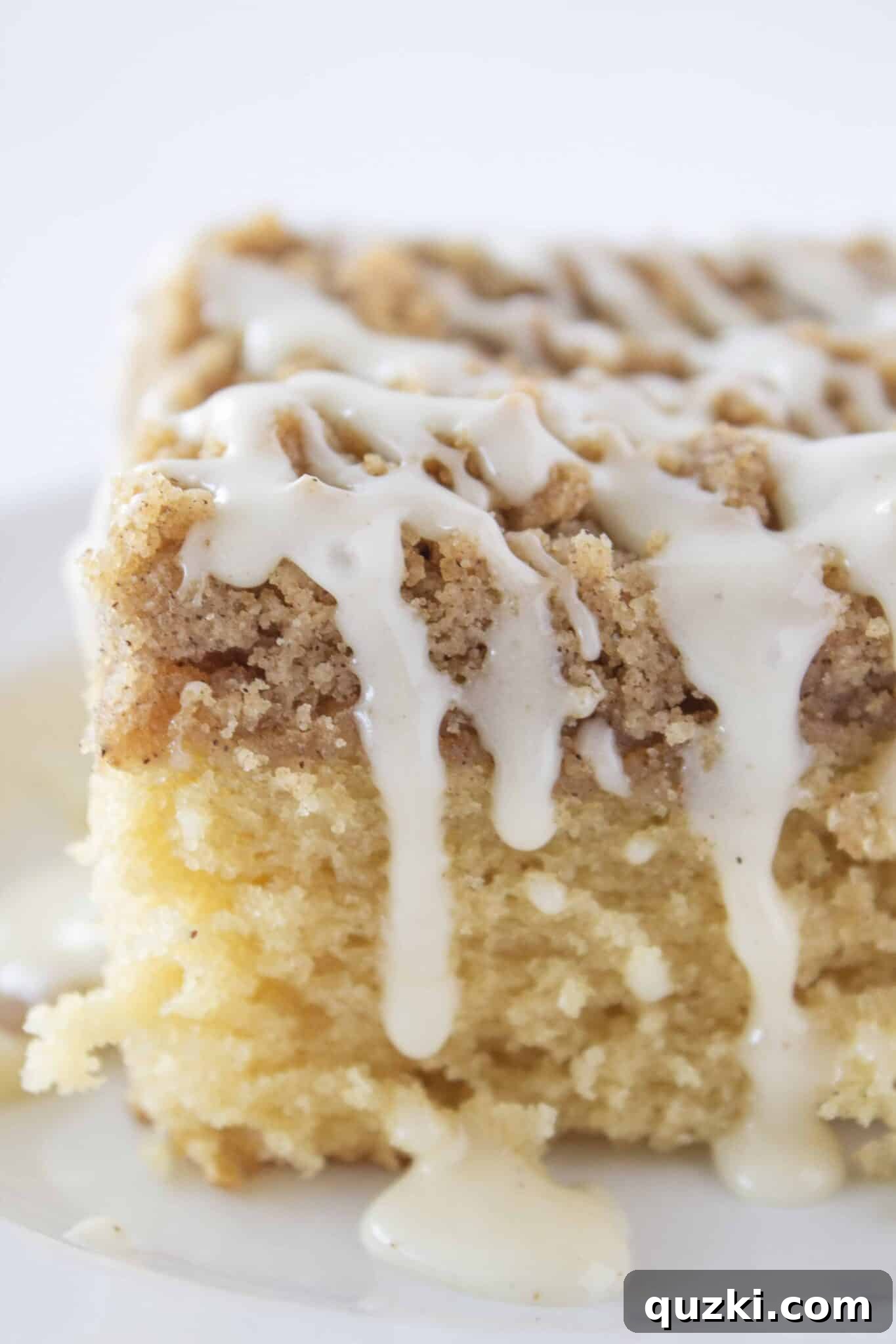 Sweeten Your Christmas Morning: Eggnog Coffee Cake 9 A warm slice of Eggnog Coffee Cake with glaze, served and ready to enjoy.