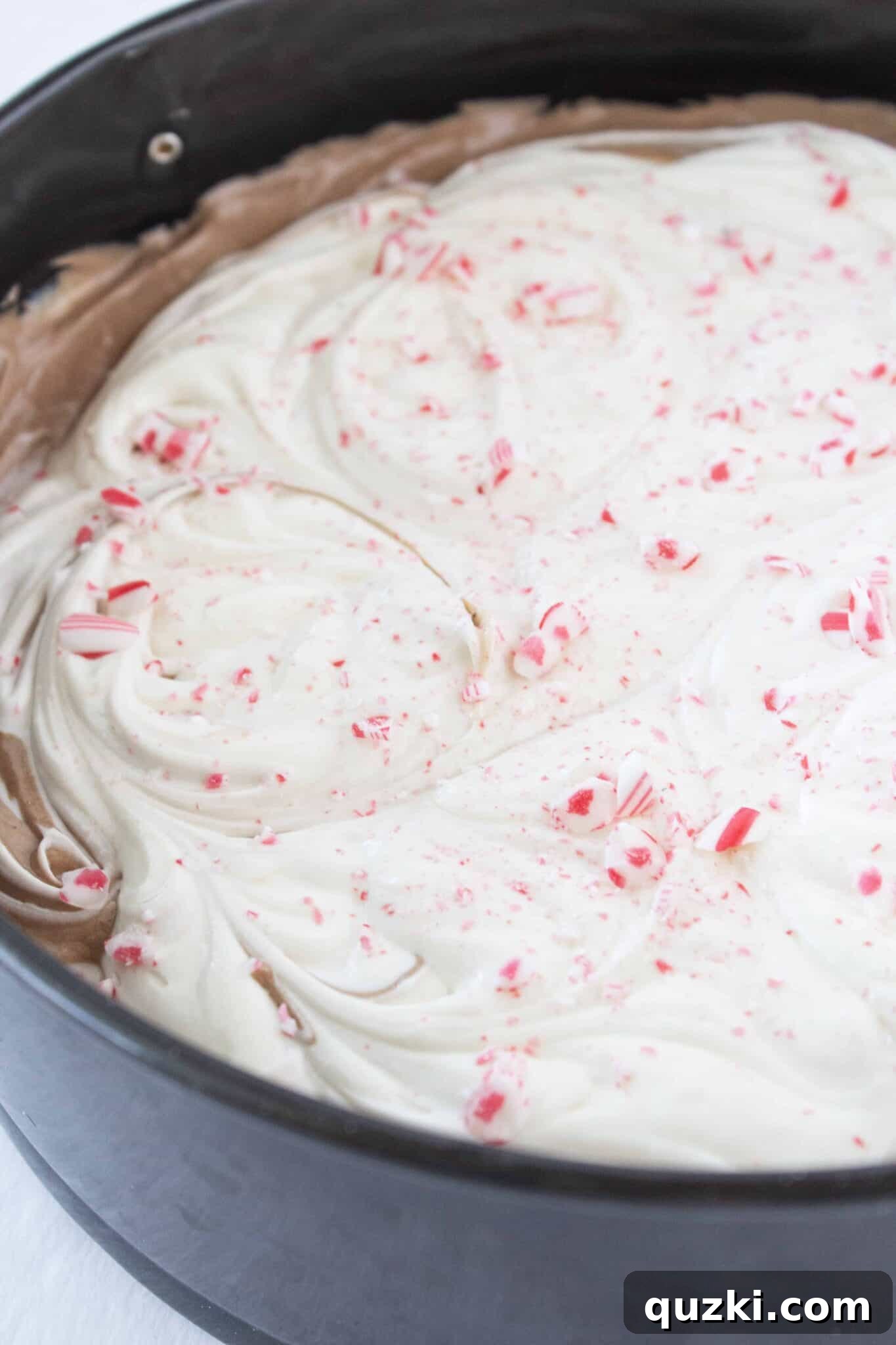 Adding a generous sprinkle of crushed peppermint pieces to the top of the cheesecake for flavor and decoration.