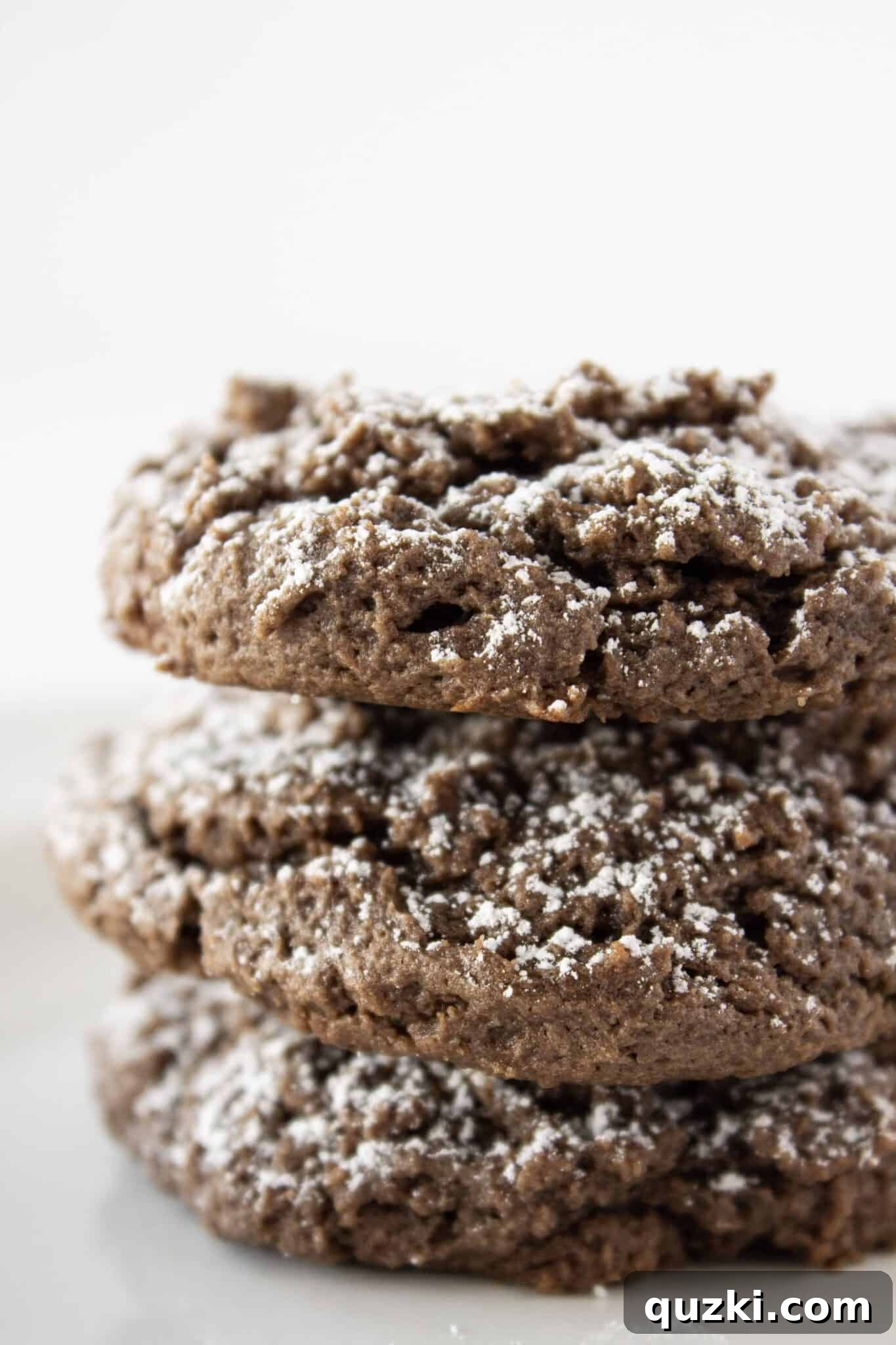 Effortless Cake Mix Cream Cheese Chocolate Cookies 3 Close-up of freshly baked Chocolate Cream Cheese Cake Mix Cookies, showcasing their soft texture and powdered sugar dusting