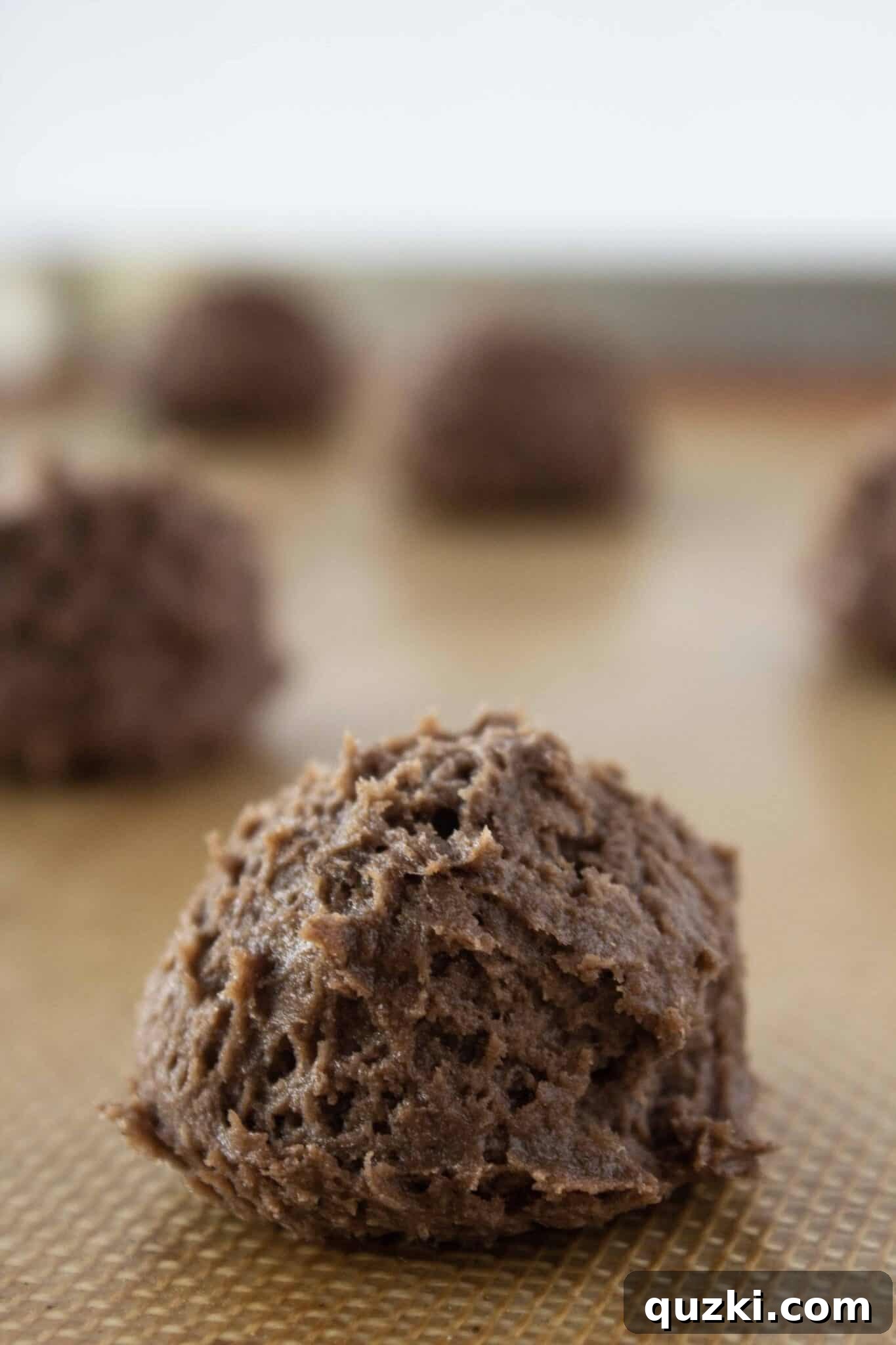 Effortless Cake Mix Cream Cheese Chocolate Cookies 6 Step-by-step: Scooping uniform portions of chocolate cream cheese cookie dough onto a baking sheet