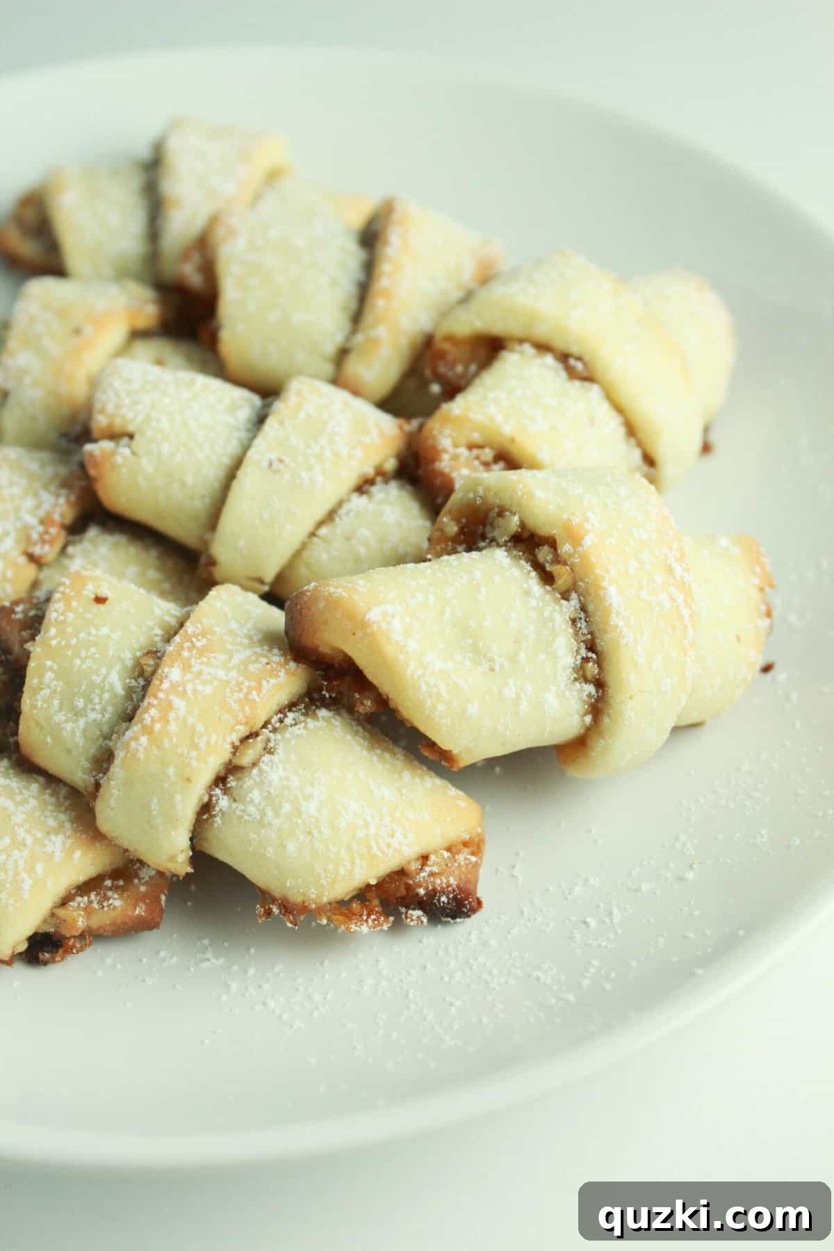 Delicious Honey Nut Rugelach cookies made with cream cheese sugar cookie dough, beautifully spiraled