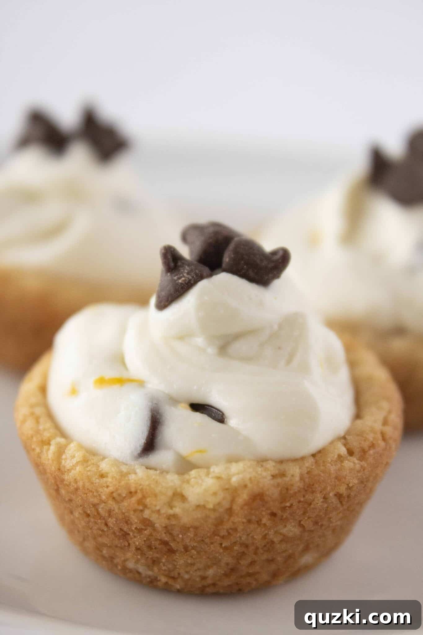 Three perfectly crafted Cannoli Cookie Cups presented on a plate, showcasing their inviting texture.