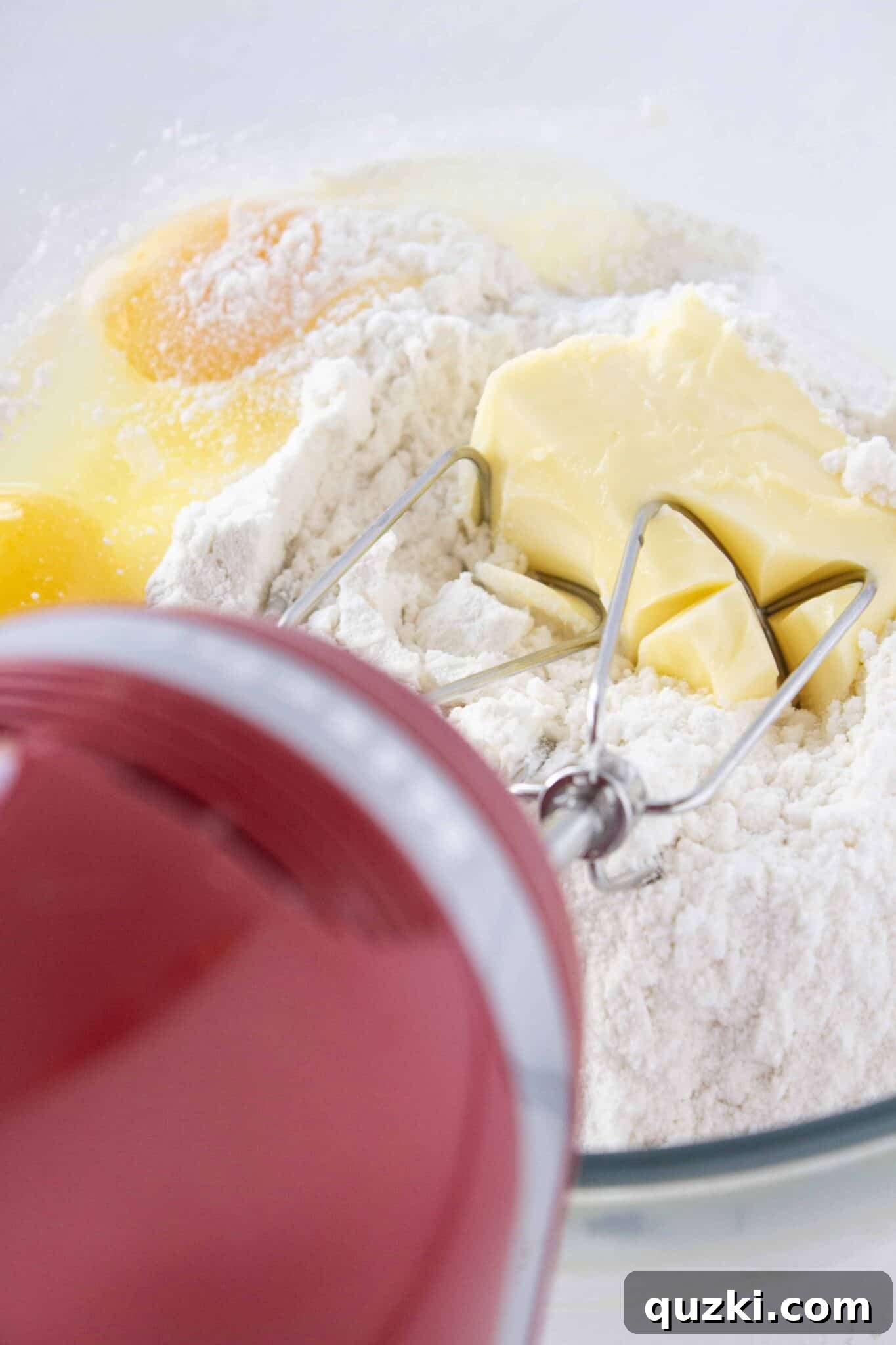 Mixing the cookie dough, made from a vanilla cake mix and softened butter, to achieve the ideal texture.