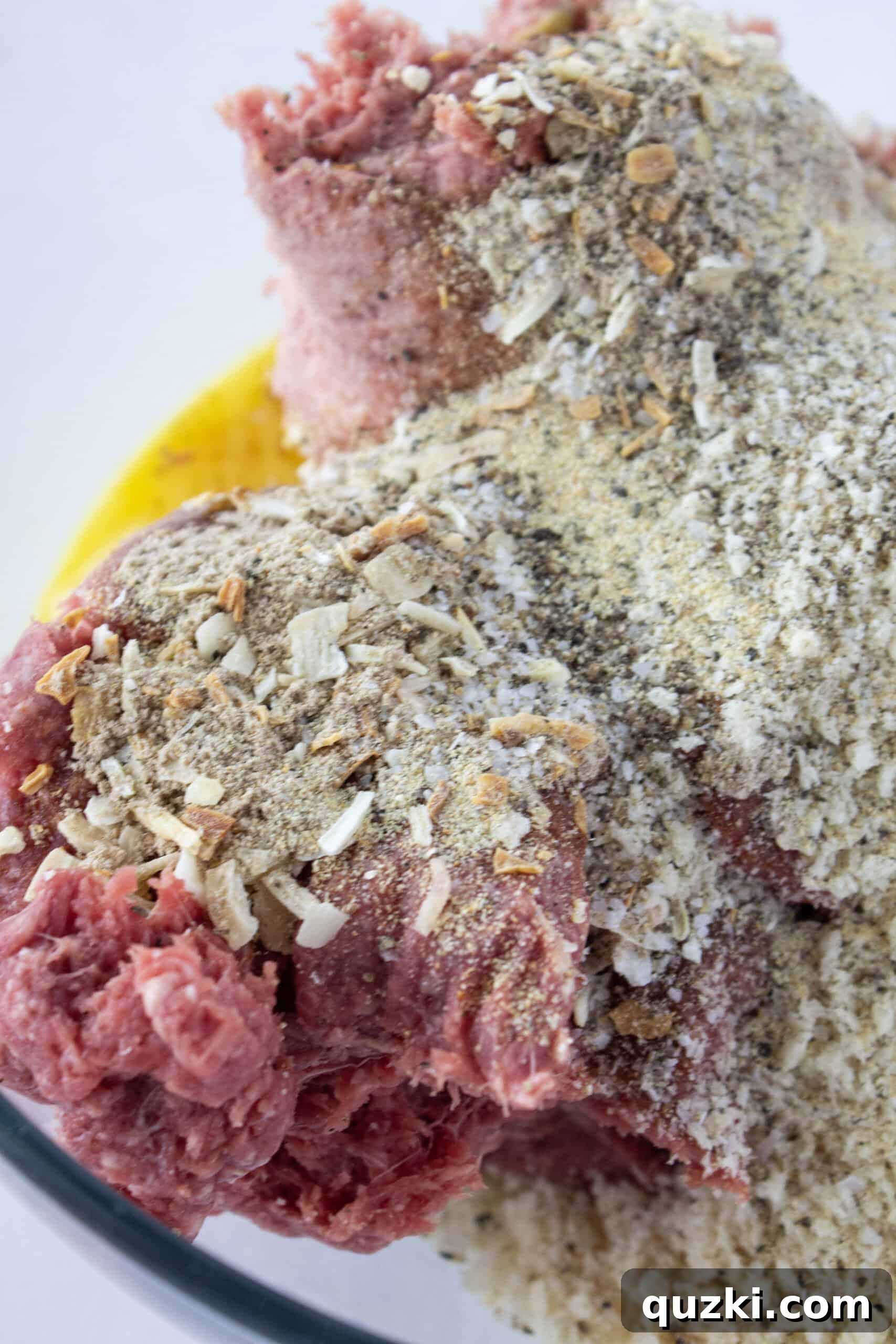 Mixing the meatloaf ingredients in a bowl.