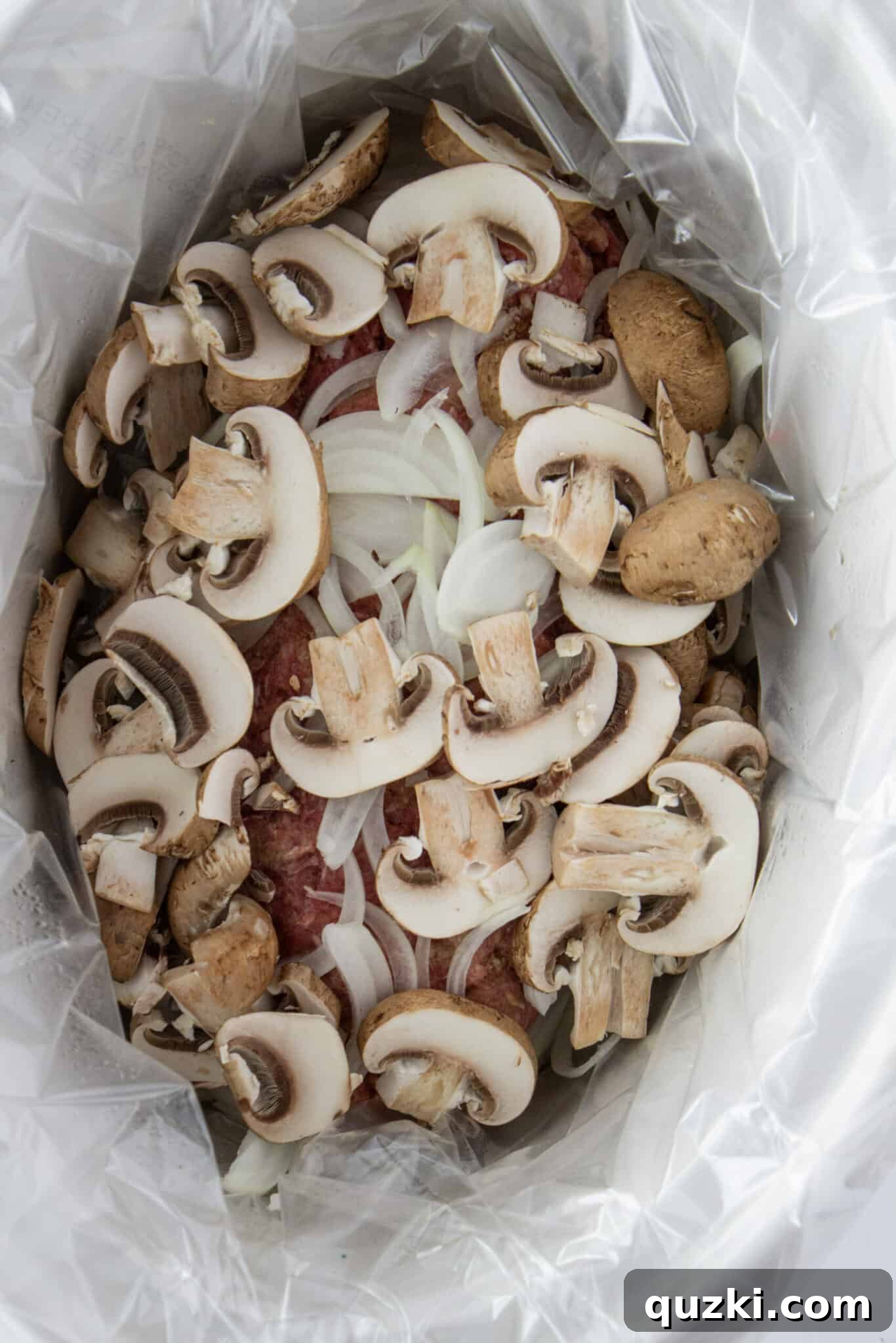 Pouring the creamy stroganoff sauce over the cooked meatloaf.