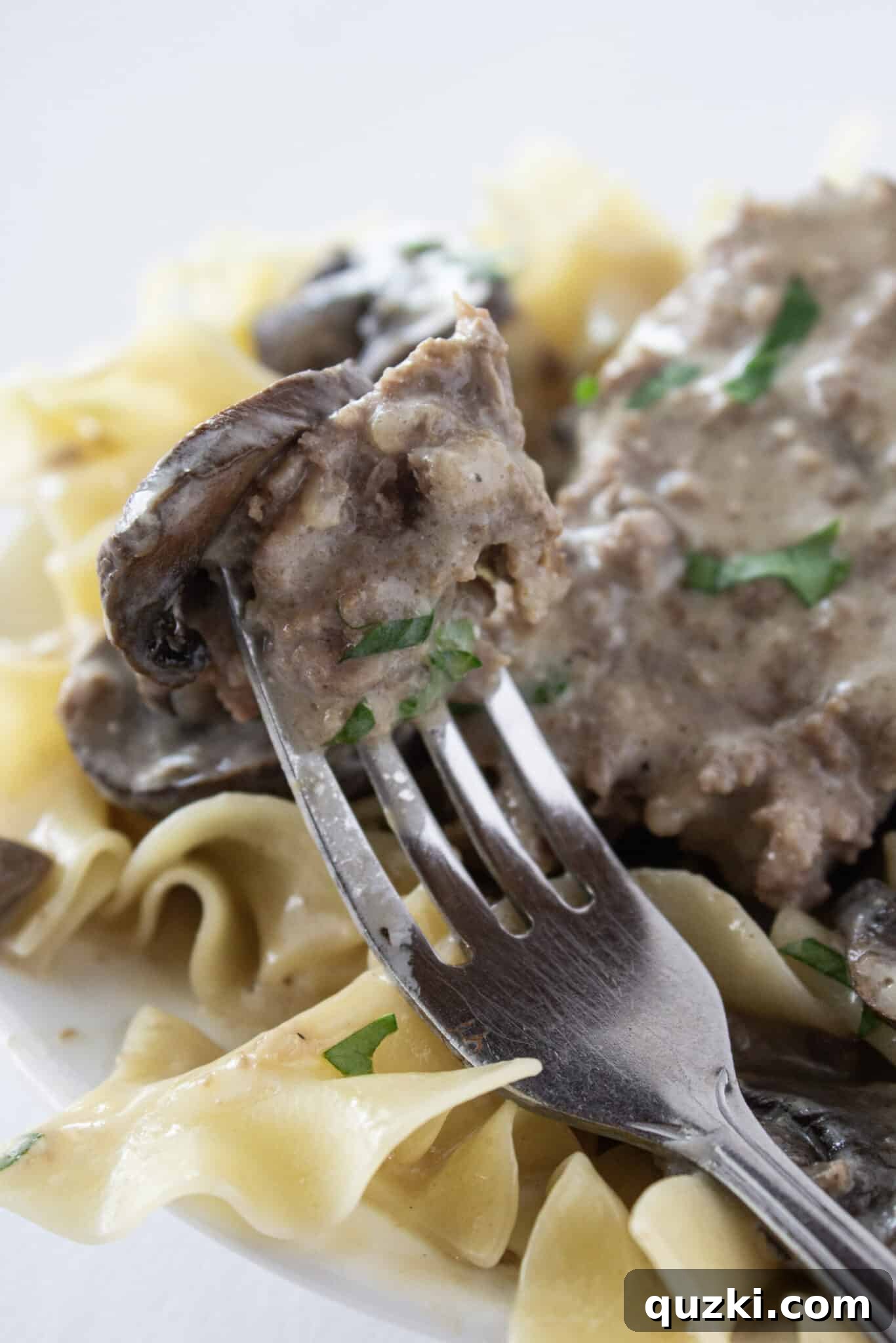A bite of Easy Crock Pot Beef Stroganoff Meatloaf on a fork.