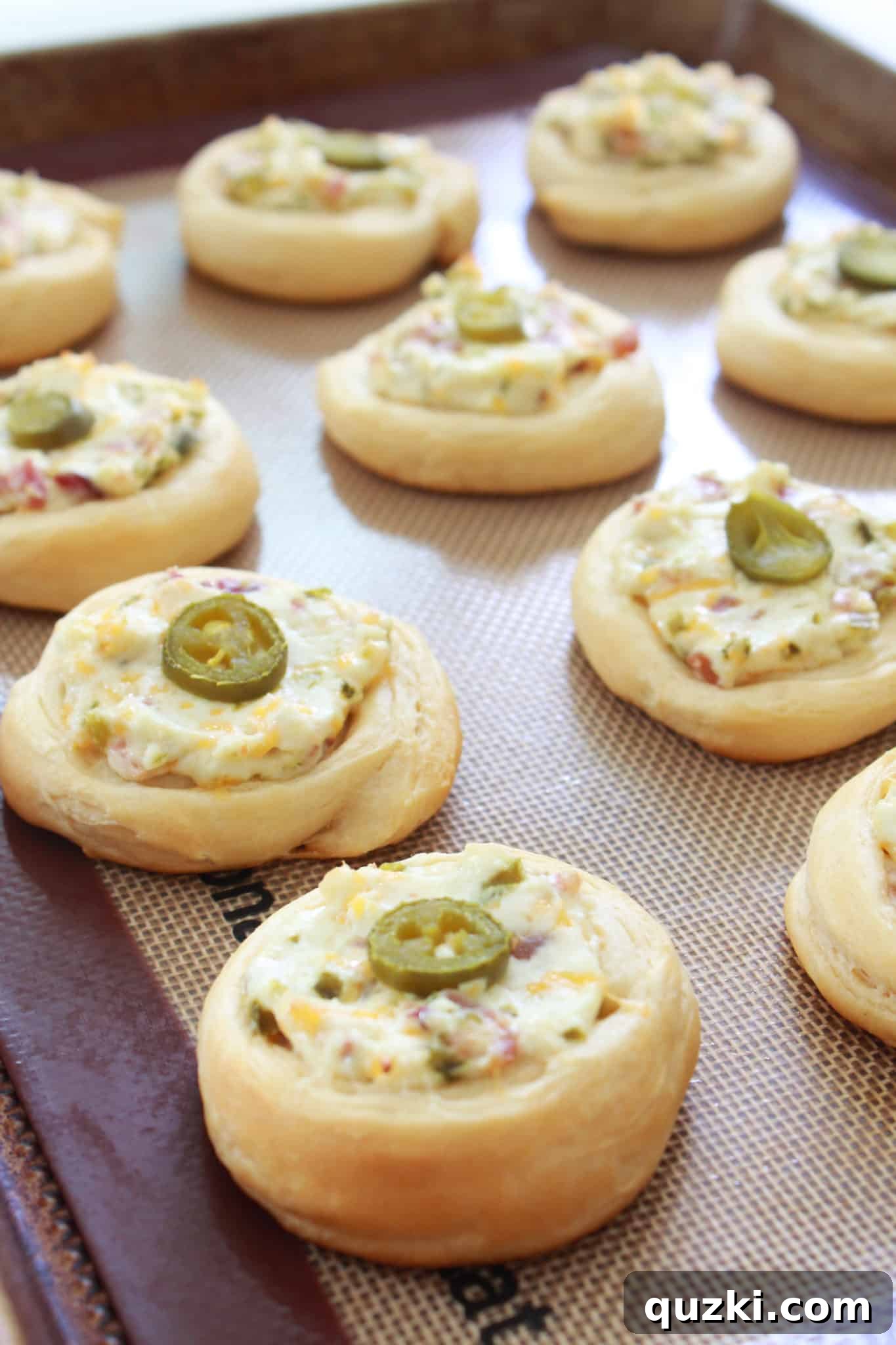 Spicy Jalapeno Popper Crescent Bites arranged on a platter, ideal for a festive New Year's Eve party