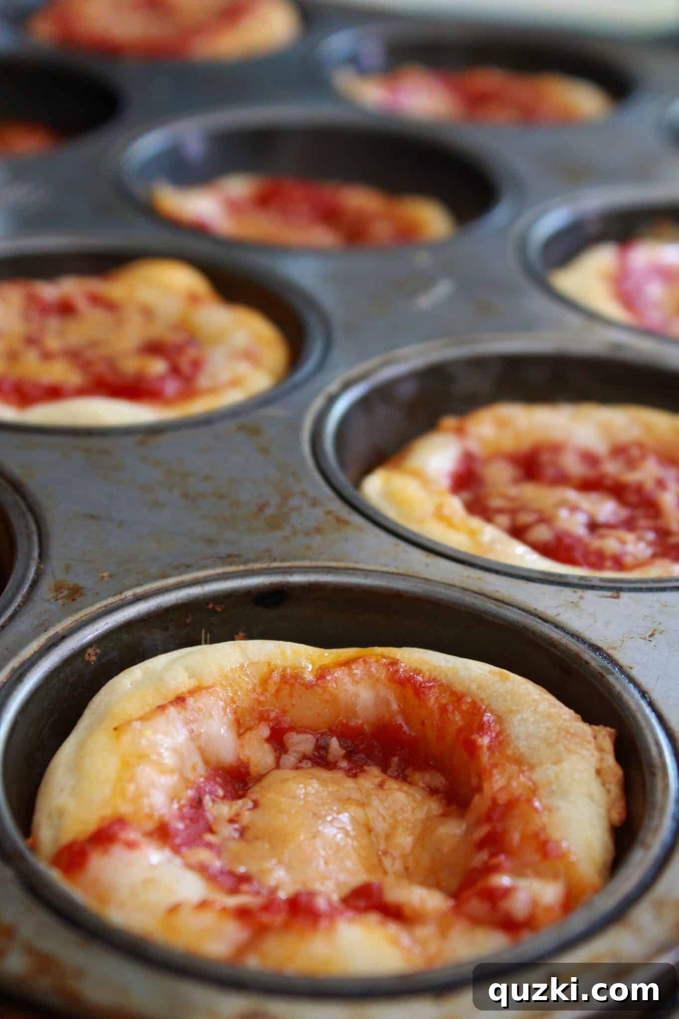 Mini Deep Dish Pizzas in a muffin tin, a fun and easy New Year's recipe for pizza lovers