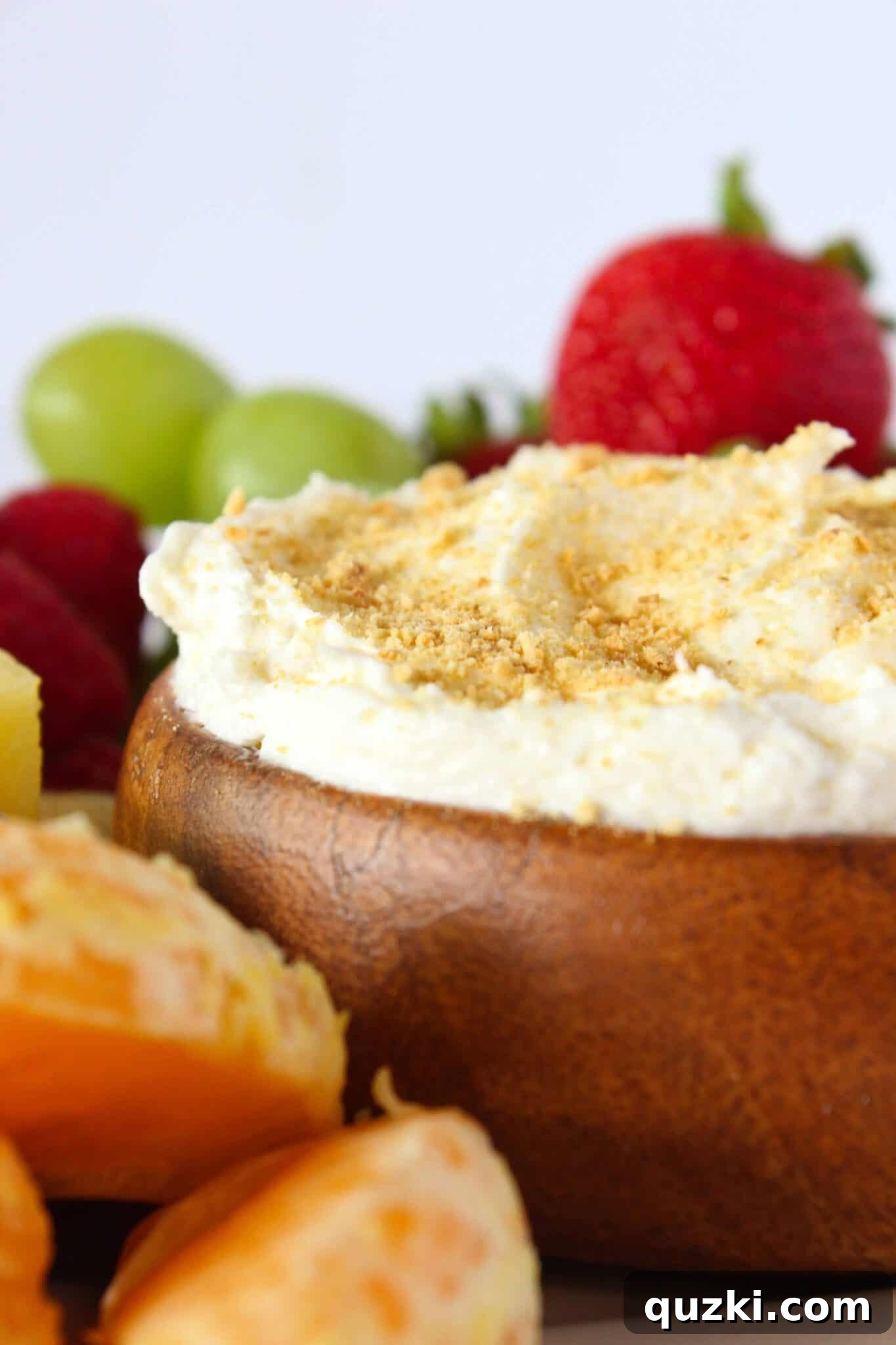 Easy Cheesecake Fruit Dip served with an assortment of fresh fruits, a light and sweet New Year's dessert idea