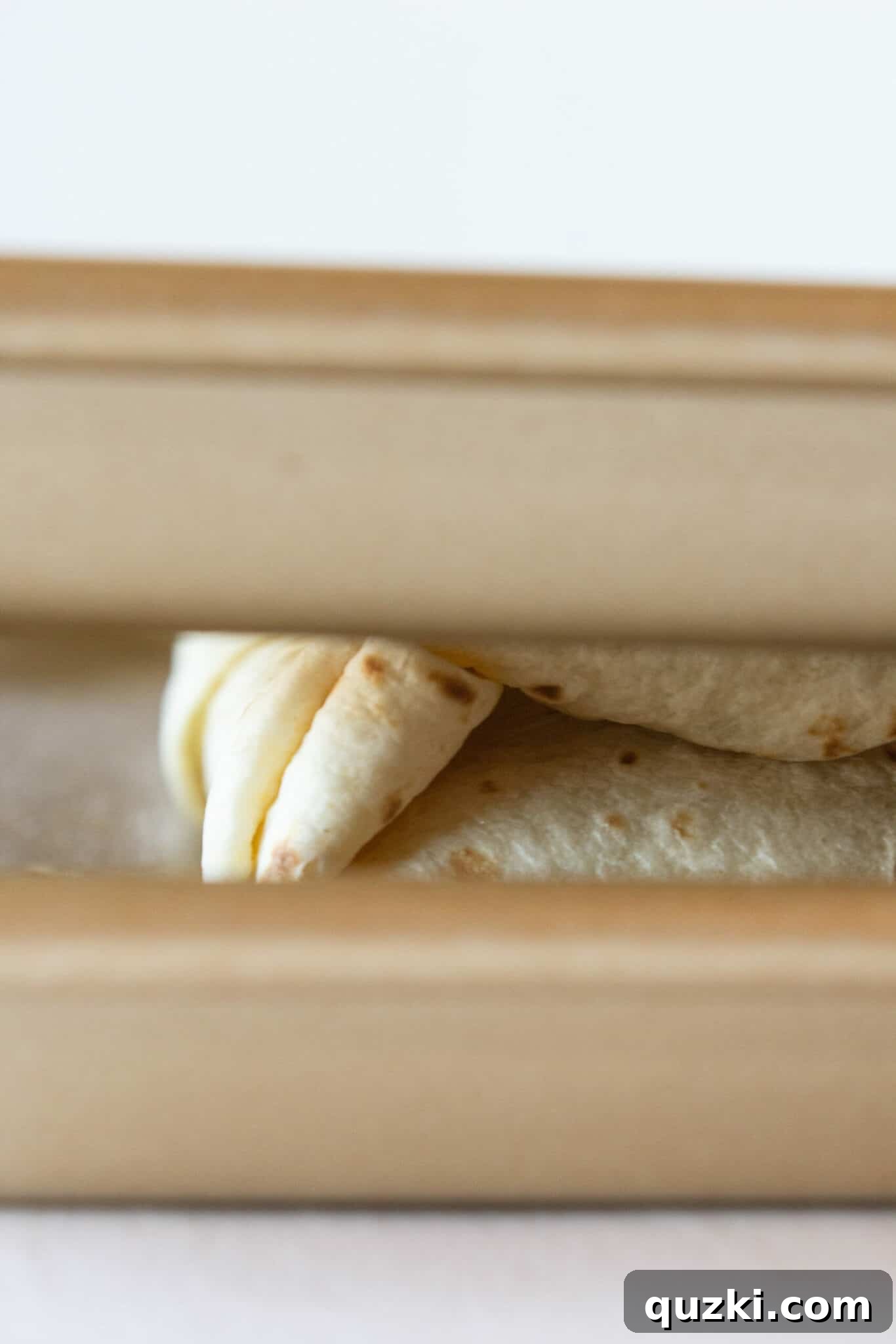 Easy Sheet Pan Breakfast Quesadillas 11 Folding the Sheet Pan Breakfast Quesadillas for baking.