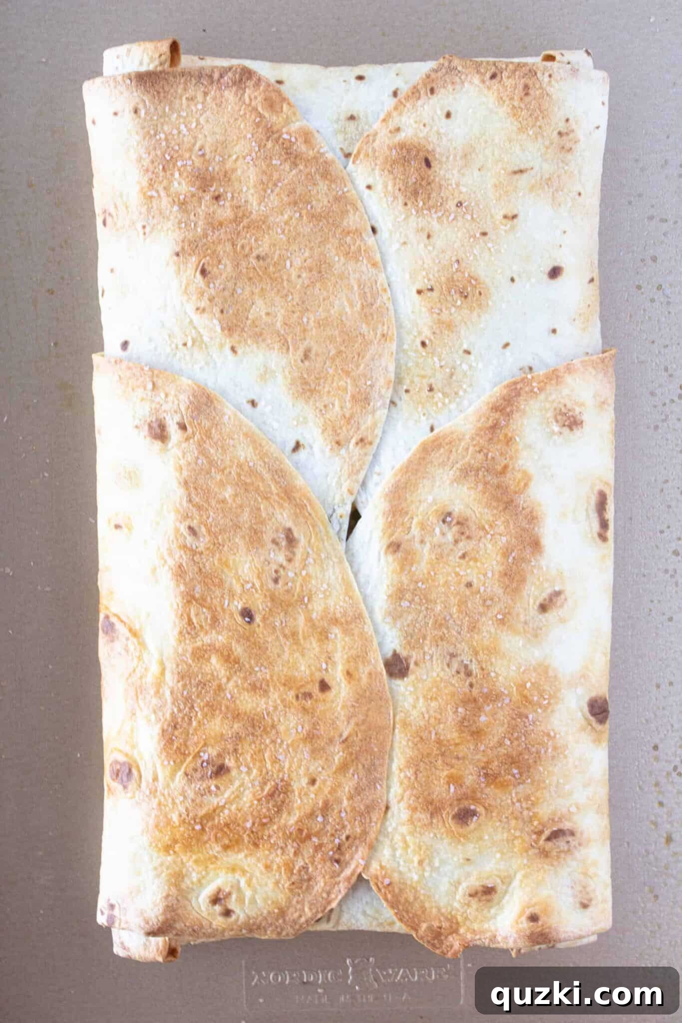Easy Sheet Pan Breakfast Quesadillas 12 A baked Breakfast Quesadilla on a sheet pan.