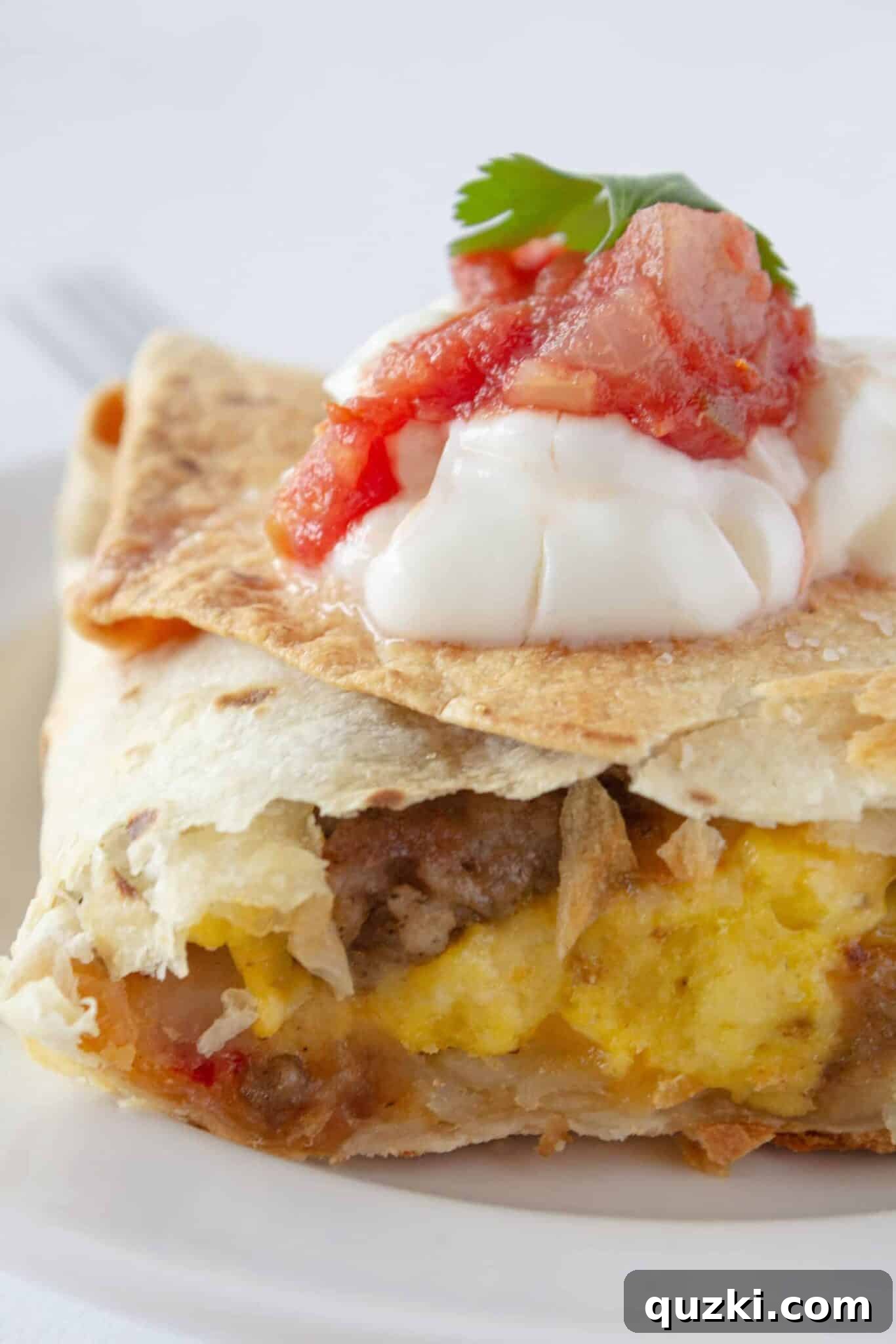 Easy Sheet Pan Breakfast Quesadillas 15 Sheet Pan Breakfast Quesadilla serving on a plate with toppings.