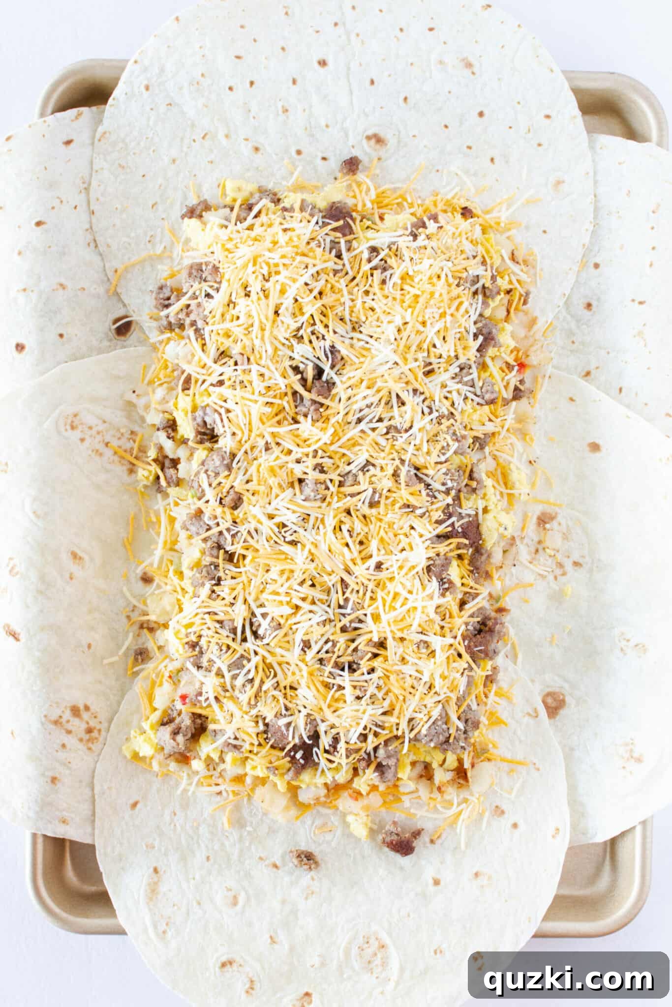 Easy Sheet Pan Breakfast Quesadillas 9 Finishing with a layer of cooked sausage and more cheese.