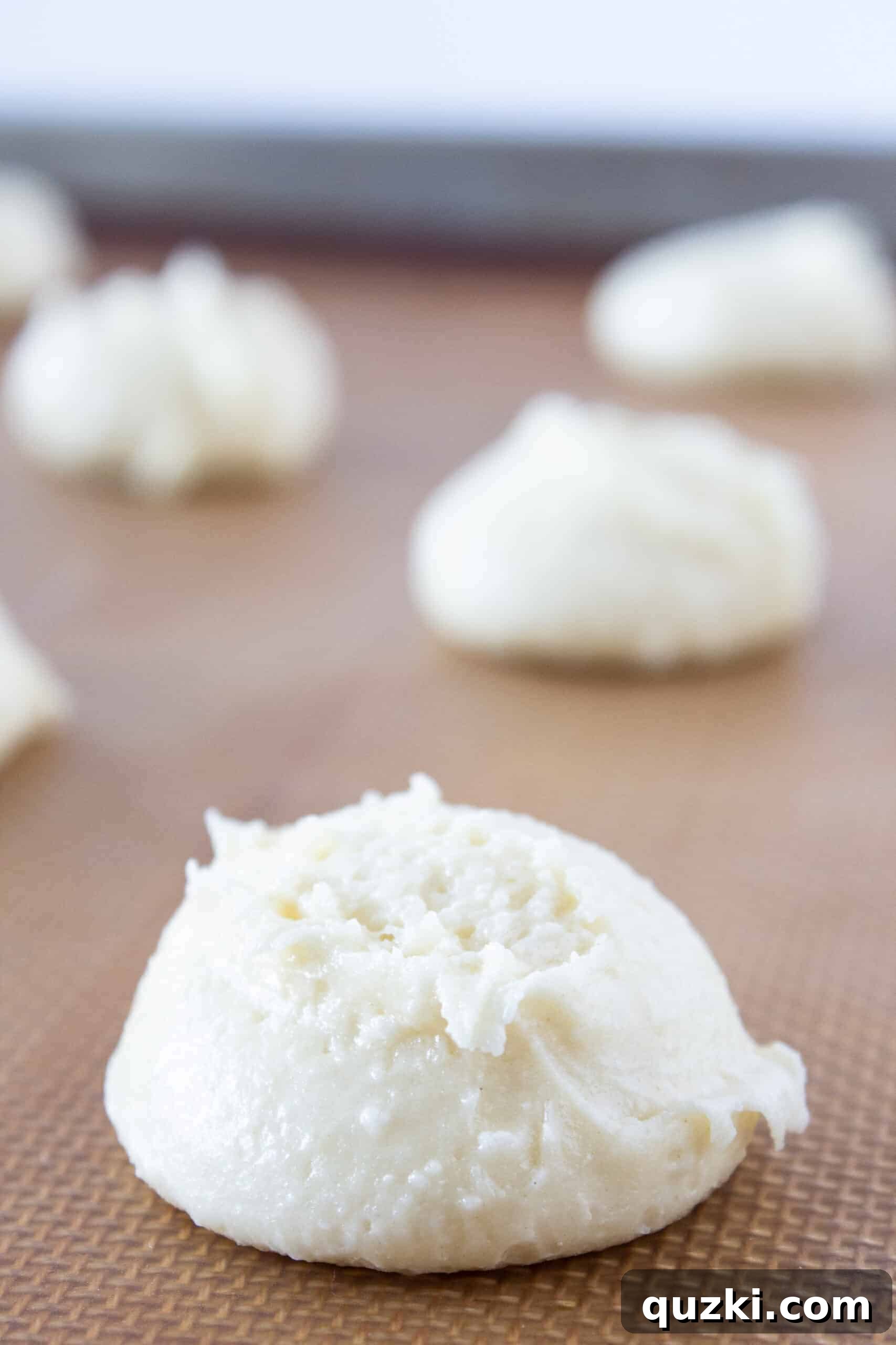 Cake Mix Magic: White Sheet Cake Cookies 5 White Sheet Cake Cookies dough portions scooped onto a silicone mat lined baking sheet.