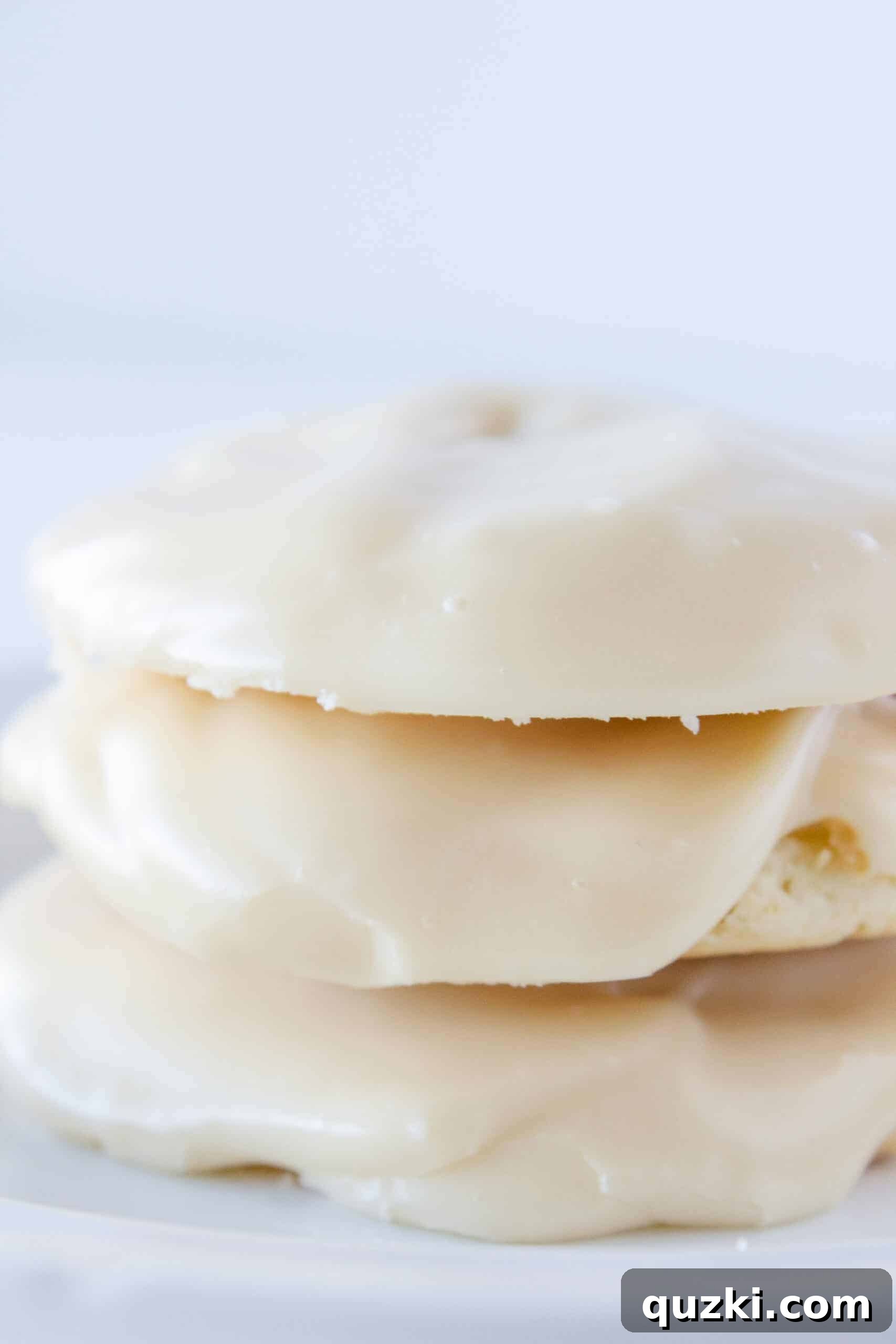 Cake Mix Magic: White Sheet Cake Cookies 10 A stack of perfectly glazed White Sheet Cake Cookies on a rustic wooden surface.