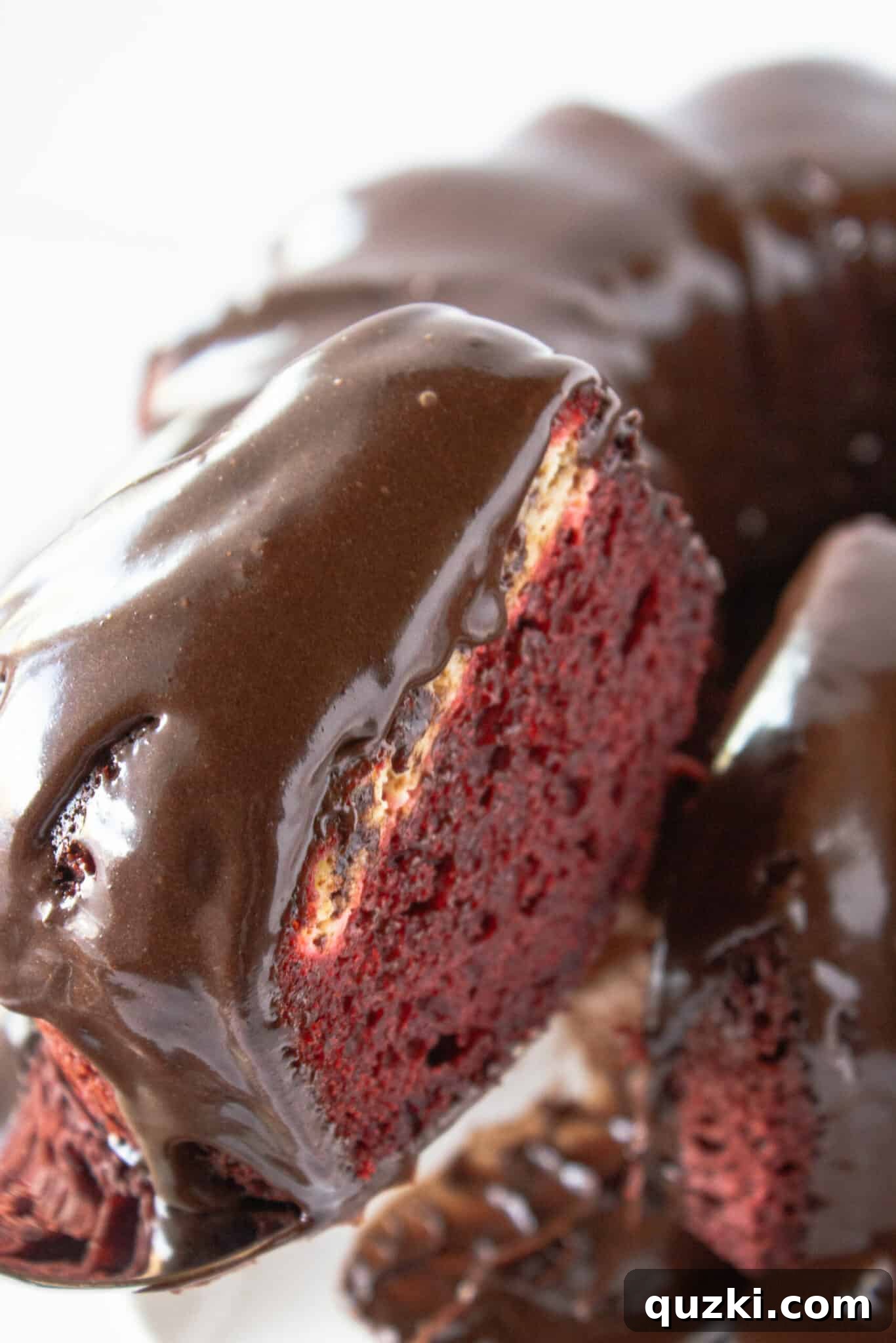 Black Bottom Red Velvet Bundt Cake Made Easy 3 Serving a generous slice of freshly baked Red Velvet Bundt Cake, ready to enjoy.